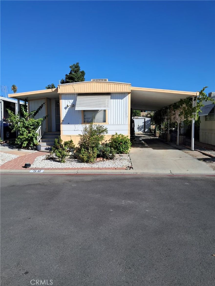 Welcome to this beautifully maintained single-wide mobile home located in a quiet and friendly senior community. This home offers plenty of parking with a covered carport that accommodates up to three vehicles. Enjoy a spacious covered porch—ideal for barbecues, entertaining guests, or simply relaxing outdoors.
The property features several mature fruit trees, including avocado, lemon, lime, and guava, providing fresh fruit right from your own yard. The community is well-kept and offers great amenities such as a sparkling pool, clubhouse, and recreational facilities.
With low space rent compared to the area, this home provides excellent value in a peaceful 55+ neighborhood where pets are welcome. Whether you’re looking for an active lifestyle or a tranquil retreat, this home is the perfect blend of comfort and convenience.