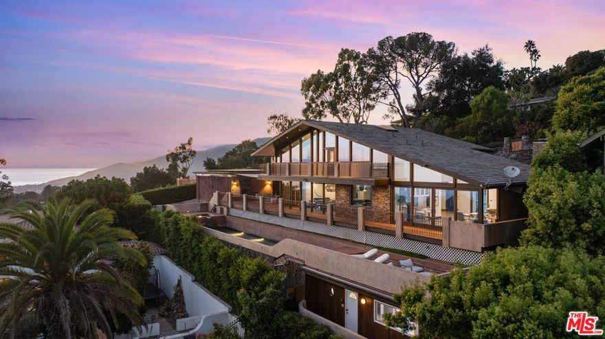 Breathtaking Pacific Palisades Mansion with Panoramic Ocean Views! Welcome to this magnificent 6-bedroom, 8.5-bathroom estate designed by the renowned architect Ray Kappe, offering unparalleled panoramic views from Downtown LA to Catalina Island, the Queen's Necklace, and the beaches of Malibu. Situated in the heart of Pacific Palisades, this stunning property is located moments from hiking and biking trails and all the best the neighborhood has to offer. Remodeled in the early 2000s, this home sits above the serene grounds of Lake Shrine, boasting the best views in the neighborhood. Floor-to-ceiling windows throughout capture the sweeping coastline, creating an incredible setting for both private relaxation and entertaining.The heart of the home features a fully equipped cook's kitchen with an open-concept design that flows seamlessly into the formal dining area, perfect for hosting. Additional highlights include multiple family rooms, a media/screening room, an exercise studio with an en suite bathroom, maid's quarters, and a custom wine cellar with a tasting area. Outdoors, enjoy the expansive deck overlooking the Pacific, with direct access to the lap pool and spa below a perfect backdrop for sunset gatherings or lounging in the sun. The two luxurious primary suites offer breathtaking ocean views, while the remaining three suites all include private en-suite bathrooms. This estate is equipped with an Enphase Solar Energy system for independent energy efficiency. The property includes a separate 3-car covered garage and a spacious 50' x 75' lower parking area capable of accommodating up to seven cars plus an RV, providing exceptional convenience. A charming guest house with a kitchenette and bathroom sits below the pool area, offering a peaceful retreat for guests. Experience luxury coastal living in this Zen-like atmosphere exceptional one-of-a-kind Pacific Palisades home, offering an unmatched blend of architectural elegance, modern amenities, and sweeping ocean views.