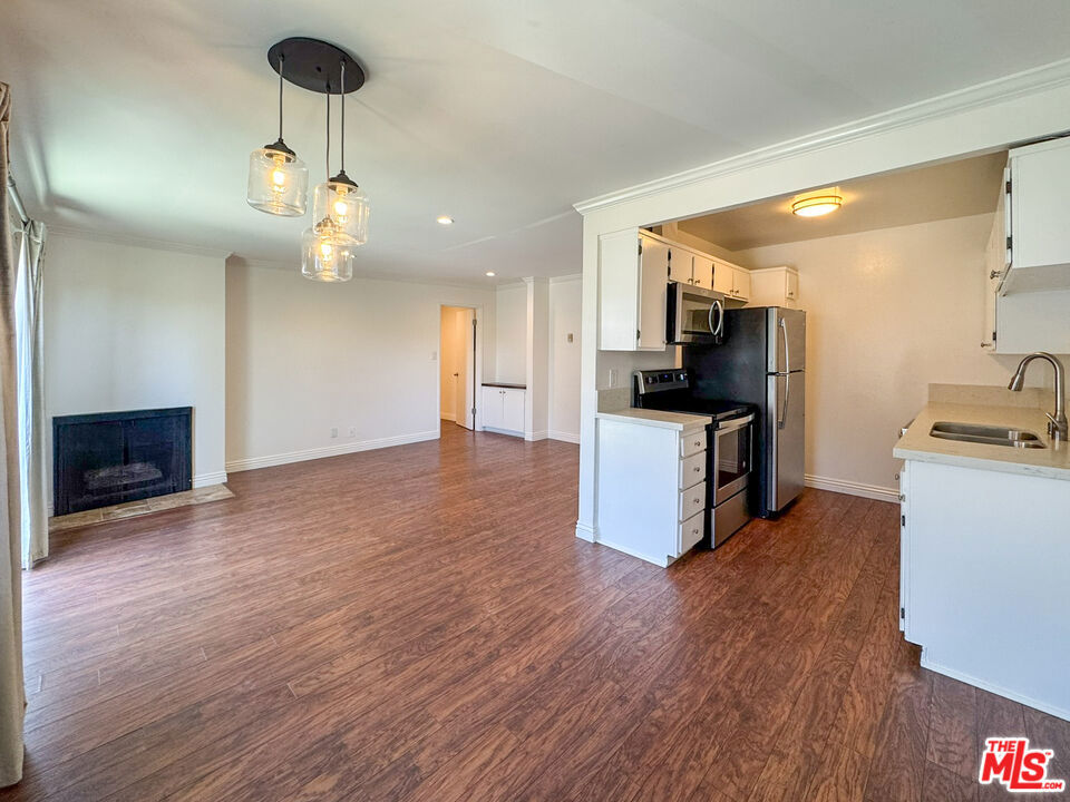 Welcome to this fantastic top floor 1-bedroom, 1-bath unit offering a spacious semi-open floor plan designed for both comfort and functionality. The bright living room features a charming fireplace as its centerpiece and opens to a private balcony. Just off the living area, the dining space flows seamlessly into a fully equipped kitchen with a stove, refrigerator, microwave and dishwasher. The bedroom is generously sized with a large closet and sleek recessed lighting, while the full bathroom includes a convenient shower and tub combination. Additional closet space in the hallway adds to the unit's practical storage solutions. Residents enjoy access to a range of community amenities including an indoor heated pool, relaxing hot tub, barbecue area, recreation room, and an on-site laundry room. The unit comes with one assigned parking space and two private storage units located above the parking area. Tenant is responsible for all utilities except gas, Trash and water. Sorry, no pets.
