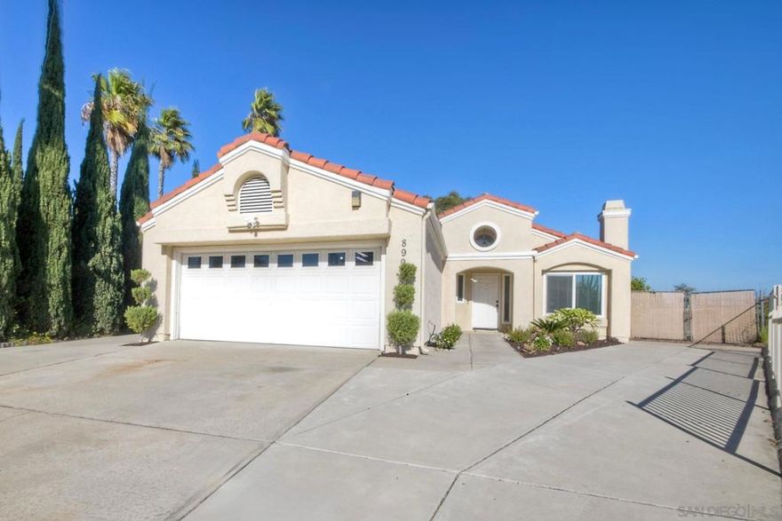 Tucked away at the end of a quiet cul-de-sac, this immaculate 3-bedroom, 2-bath home offers the perfect blend of comfort, style, and functionality. With over 17,000 square feet of lot space, the possibilities are endless—whether you're dreaming of building an ADU, adding a pool, setting up a workshop, or parking your RV, this property can accommodate it all. Inside, the home is move-in ready, featuring newly updated bathrooms, an upgraded kitchen, and beautiful laminate flooring throughout. The spacious living room is centered around a cozy fireplace, creating a warm and welcoming space for gatherings.  The home is designed for modern living, with dual-pane windows for energy efficiency, central A/C for year-round comfort, and leased solar panels to help keep energy costs down. The open kitchen boasts contemporary finishes and flows seamlessly into the dining and living areas—ideal for entertaining or everyday family life. The bedrooms are generously sized, and the primary suite offers serene backyard views, giving you a front-row seat to nature with visits from local birds, raccoons, and other wildlife.  Step outside to your private backyard oasis, where a covered patio invites al fresco dining and relaxation. A view deck sits at the back of the property, providing a peaceful retreat to enjoy sunsets, wildlife, or your morning coffee. The oversized lot also includes drive-through access, making it easy to bring in vehicles, tools, or equipment. With parking for at least four additional cars, hosting friends and family is a breeze.