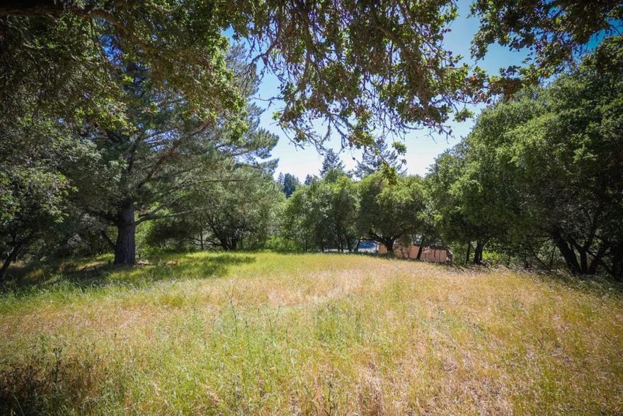 Almost a half and acre with a beautiful meadow tucked in a serene setting!  Prior owners did a lot of work to determine buildability and potential.  This property has all the infastructure available to be able to build....sewer, water, electricity.  What would you like to create here?  Let's talk about the possibilities. Excellent Scotts Valley schools, easy freeway access, and not far to shopping and beaches!