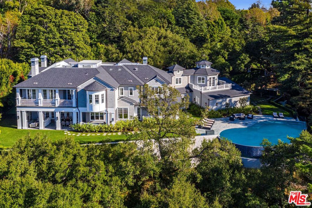 Situated in the prestigious Brentwood Hills, The Oakmont Estate is a breathtaking private and gated retreat in Mandeville Canyon. Set on over an acre of beautifully manicured grounds, just minutes from Sunset Blvd, this approx. 12,344 SF home offers the perfect harmony of tranquility and convenience. Designed by the renowned architect Philip Vertoch and brought to life by the meticulous Gordon Gibson, this 6BD, 11BA home is truly a masterpiece. The residence is a stunning Hamptons-inspired estate with interiors by AD100 designer, Brigette Romanek. Featuring a refined neutral color palette, dark hardwood floors, and soaring ceilings that create an expansive and light-filled atmosphere. The open-concept layout seamlessly blends modern sophistication with timeless charm. Spacious primary suite with spa-like bathroom and private balcony with canyon views. The latest and greatest amenities including a theater with Dolby Atmos sound, fitness room, and an incredible home office with private balcony. Outdoor entertainment areas - including a covered patio with a fireplace and dining area, built-in BBQ, a putting green, and an infinity pool with spa - all overlook the canyon views. Live in luxury within easy reach of world-class shopping, dining, and entertainment in Brentwood Village.