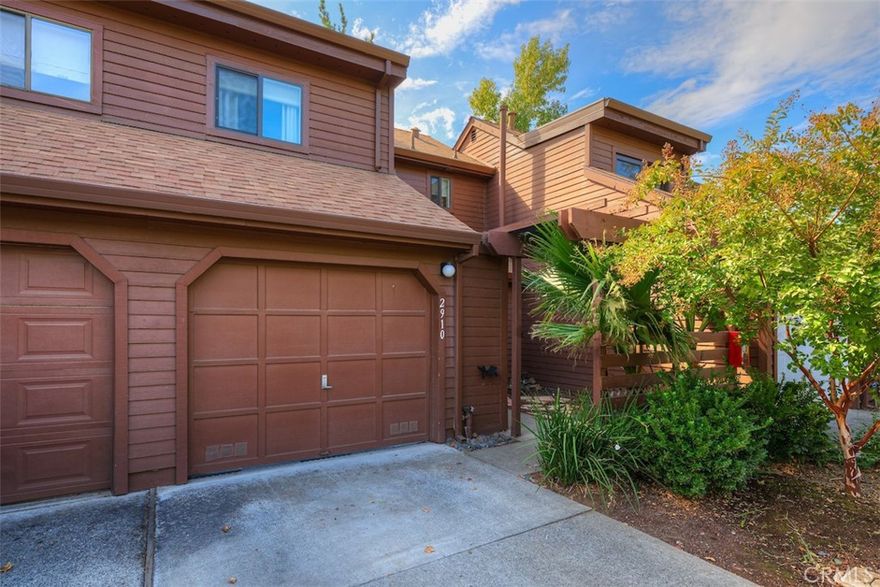 Welcome to this beautifully updated condo, showcasing over $50,000 in recent renovations completed within the last two years. This home shines with modern upgrades and thoughtful design, offering both style and functionality. Freshly painted walls, new carpets, and sleek tile flooring create a bright and inviting atmosphere. Large windows and updated lighting enhance the open, airy feel. The kitchen boasts custom cement sinks and countertops, newly installed cabinets, and an open layout with a removed wall, providing extra counter space and seamless flow into the living area. All kitchen appliances, plus a stackable washer and dryer (installed 2023), are included. A custom storage area under the stairs features a charming sliding barn door, maximizing space and style. A brand-new HVAC system ensures year-round comfort. Enjoy a private back porch surrounded by mature landscaping and a fully enclosed front courtyard, perfect for relaxing or entertaining. Centrally located within the complex, away from busy roads, with easy access to California Park’s walking trails, the association pool, and nearby mailboxes. This move-in-ready condo blends modern upgrades with a serene, convenient lifestyle. Don’t miss your chance to own this gem—schedule a showing today!