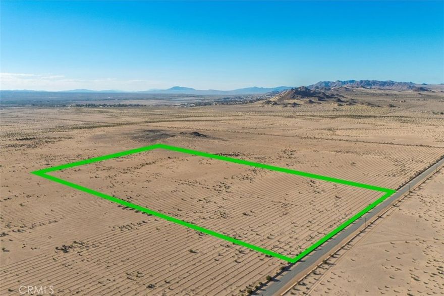 Imagine owning a 19.55-acre desert oasis in the heart of 29 Palms, a fully graded parcel with paved access and utilities ready at the street, waiting for your vision to take shape in California’s enchanting Hi-Desert.  This isn’t just land—it’s a canvas, meticulously prepared, compacted, and leveled to save you thousands in site preparation, permitting, and drainage costs.  Water mains run along both the east and west perimeters for straightforward, cost-effective hookups (see attached Water District map), with power provided by Pacific Gas & Electric through the 29 Palms Water District.   Well-maintained paved roads ensure year-round accessibility, and steel survey markers clearly define all corners for seamless planning.  With flexible RL 2.5 zoning, this property accommodates a wide range of residential or mixed-use projects, and permitting is handled efficiently by the local 29 Palms Planning Department, known for its personable service and streamlined processes—avoiding the delays of San Bernardino County. Despite its tranquil, remote ambiance, the area enjoys excellent 5G coverage, keeping you connected for work, leisure, or staying in touch with loved ones.  Set on a broad plateau, this parcel offers breathtaking 360° views of Wonder Valley, the Cleghorn Lakes Wilderness, Joshua Tree National Park, and the majestic Mount San Gorgonio to the west, with horizon-to-horizon stargazing that’s truly unmatched.   Adding unique character, a thriving mosaic of jojoba shrubs hints at the land’s past as an artisanal jojoba farm.Location is everything, and this property delivers: just 10 minutes from vibrant downtown 29 Palms and Starbucks, 13 minutes from the North Entrance of Joshua Tree National Park for world-class outdoor adventures, and a short 45-minute drive to downtown Palm Springs for premier shopping, dining, and medical facilities.  This rare, move-in-ready property blends unmatched accessibility, utility convenience, and boundless potential.  Whether you dream of a desert retreat, a creative haven, or a savvy investment, this 29 Palms gem is ready to bring your vision to life. Contact us today to seize this one-of-a-kind opportunity!