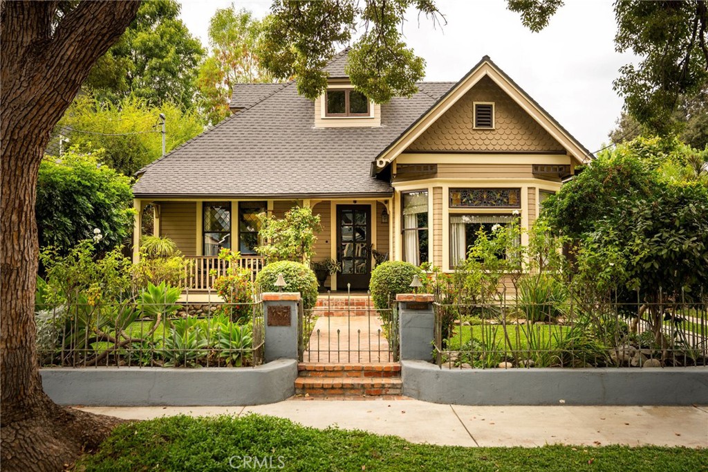 Step into Pasadena’s rich history with this beautifully restored Queen Anne Victorian, perfectly situated on a tree-lined street in the Raymond-Esther Landmark District. This home has been cared for with exceptional attention to detail, preserving its timeless character and charm. From its exquisite and extensive millwork to its gorgeous stained and leaded-glass windows and expansive backyard, it’s hard not to be captivated by the magic of this rare property. With 3 bedrooms, 2 bathrooms, and 2,187 square feet, the layout offers generous space for daily life. The floor plan flows gracefully from room to room, creating a sense of openness while still maintaining the cozy intimacy that makes these older homes so beloved. Each space has its own personality—from the sunlit kitchen that invites morning coffee and conversation to the formal dining room, perfect for big family gatherings, to the adjacent living room adorned with rich wood and a welcoming fireplace—you’ll never be stuck in the same attitude. All of this comes with thoughtful modern upgrades, including dual-zone air conditioning, a gas fireplace, and kitchen skylights that fill the space with natural light. The outdoor space is equally special, offering both beauty and functionality. The expansive, tree-shaded yard provides a serene escape—perfect for quiet mornings, playful afternoons, or lively evening gatherings with friends and family. The lush landscaping and mature trees create a sense of privacy and tranquility rarely found in the city. At the back of the property, the charming, shingled storybook garage is extremely spacious and offers endless possibilities.
Located just minutes from the Rose Bowl, Old Town Pasadena and the iconic Gamble House, this is more than just a home; it’s a piece of Pasadena’s story, lovingly preserved and ready for its next chapter. Don’t miss the chance to make it your own.