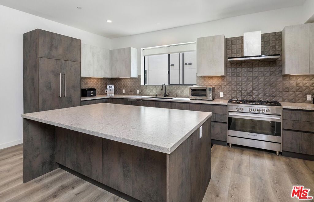 Experience upscale living in this 4BD/3.5BA detached single-family home located in the exclusive Vantage Villas community. With just over 2,400 sqft of thoughtfully designed space across three levels, this residence blends sophisticated style with practical comfort. The open-concept main floor is bright and airy, featuring soaring ceilings and seamless flow between the living and dining areas. At the heart of the home is a gourmet kitchen equipped with Fisher & Paykel appliances, Caesarstone countertops, imported porcelain backsplash, and custom Italian cabinetry with a striking two-tone finish, perfect for everyday living or entertaining in style. Outdoor living is just as impressive, with three private balconies and a large patio offering multiple options for dining, lounging, or hosting gatherings under the stars. Upstairs, the primary suite is a serene escape with a spacious walk-in closet and a spa-inspired bathroom featuring a freestanding soaking tub, dual vanity, and designer shower. Two additional bedrooms share a sleek full bath, while the lower level includes a versatile flex space with an ensuite bath and direct access to the patio, ideal for a guest suite, home office, or gym. This property also features a 3-car garage with direct access for added convenience. Situated within the award-winning Colfax Charter school district, this home is the perfect blend of modern elegance and comfort.