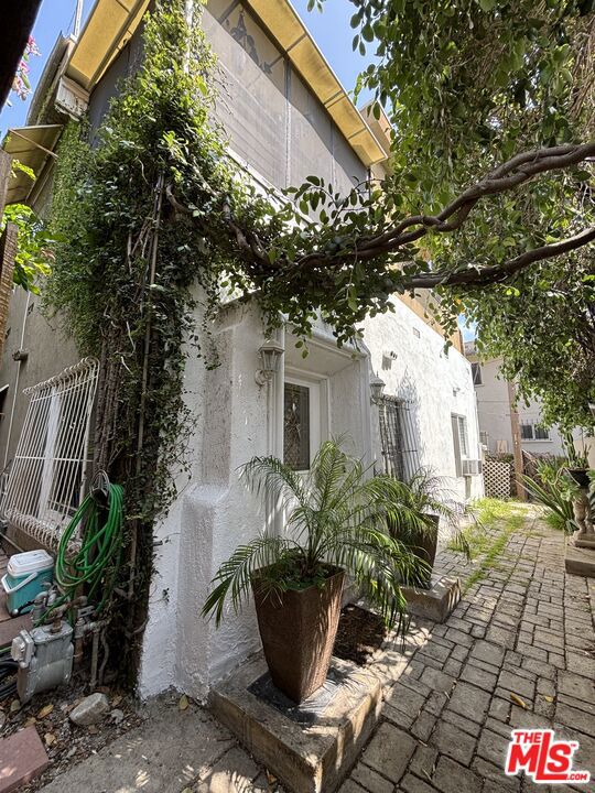 Located in a prime West Hollywood location just south of Santa Monica Boulevard, 1028 N Hayworth Avenue is a charming 1922 Spanish-style fourplex situated on a 7,102 sq ft lot (WDR3Czoning). This income-producing property features a desirable mix of two 1-bedroom/1-bath units and two spacious 3-bedroom/2-bath units. Each unit is separately metered, with tenants responsible for gas, water, and electricity helping maintain low operating expenses. Recent upgrades include Liquid Rubber Roof Treatments in 2024 across all units, multiple new waterheaters, interior renovations, and appliance replacements. With one unit vacant and another to be delivered vacant, the property offers strong upside potential through rental repositioning or possible redevelopment. Unit Breakdown * 1028 N Hayworth Ave1 bed | 1 bath | Month-to-month lease at $1,248/monthFeatures a newer hot water heater (approx. 3 years old) and received a Liquid RubberRoof Treatment in 2024. * 1028 1/2 N Hayworth Ave1 bed | 1 bath + walk-in closet or small office | Vacant (Market rent est. $2,750/month)Renovated in 2024 with new kitchen countertops, sink, fixtures, refrigerator, stove,dishwasher, and flooring. Includes in-unit laundry, window-unit heat/AC, new waterheater (2021), and Liquid Rubber Roof Treatment (2024). * 1030 1/2 N Hayworth Ave 3 bed | 2 bath | Month-to-month lease at $3,565/monthTenants moved in June 2022. Features a gas fireplace, exterior laundry, new flooring(2020), appliances replaced in 2021 (refrigerator and stove), and Liquid Rubber RoofTreatment in 2024. * 1030 N Hayworth Ave 3 bed | 2 bath | Will be delivered vacant (Market rent est. $4,750/month) Renovated in 2025 with new flooring throughout, a full downstairs bathroom renovation,and a kitchen remodel including new cabinets, countertops, sink, fixtures, andappliances. Includes exterior laundry with new washer and dryer, hot water heater replaced in 2023, wall-unit heating and AC on both floors, and received a Liquid Rubber Roof Treatment in 2024. There is no off-street parking for this property. However, the seller has had a long-standingin formal agreement with a property owner across the street to lease two tandem parking spaces for $750 per year. This arrangement has been in place for over 25 years but is month-to-month and may be terminated with 30 days' notice. This arrangement is not gauranteed to remain in place after the sale, New owners to negotiate new deal. All information provided deemed reliable but not guaranteed. Buyer and Buyer's agent to verify all information provided including but not limited to zoning, planning and permits.