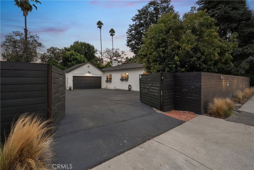 Situated on a sprawling, gated lot within the desirable Magnolia Estates pocket of Sherman Oaks, this charming estate seamlessly blends timeless character with thoughtful modern upgrades. Inside, the open-concept main living space features a tastefully remodeled kitchen equipped with top-of-the-line appliances & french limestone counters, a formal dining room and spacious living room that boasts vaulted ceilings and a cozy fireplace. French doors open to an expansive deck that invites outdoor living and entertaining. Outside, the serene backyard retreat offers a private haven surrounded by mature landscaping. There are three generously sized bedrooms and two full bathrooms, including an inviting primary suite with a walk-in closet and spa-inspired bathroom, complete with a soaking tub, separate shower and double vanity. Additional highlights include a Nest thermostat, two-car garage with laundry and gated driveway that offers abundant parking. This property is conveniently located just moments from Westfield Fashion Square, Ventura Boulevard’s premier shopping and dining, and so much more.
