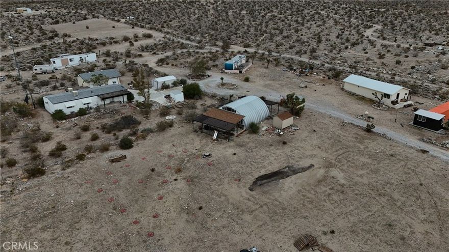 This 20 acre AG zoned property offers space, privacy, and a variety of existing structures for someone looking to create their own vision. The main home is a 2 bedroom 2 bathroom mobile home with a transferable title, and it is accompanied by two additional one bedroom one bathroom trailers that cannot be transferred. All homes will need clean up and renovation, giving buyers the chance to bring fresh life to the space. The property also includes a van and a camper that are included without pink slips, a Quonset hut, two storage containers with added rooms for extra storage, a detached four car garage, and a single car metal garage. On the far east side of the land you will find a peaceful elevated and graded area with another storage container and addition that was used as a prayer room and offers great mountain and valley views. Water is supplied by a well, but the seller reports that it has run dry. Buyers should complete a well productivity test to determine current output as there may be potential to restore function with a storage tank and pump saver depending on test results. The property is being sold AS IS and due to the condition of the structures it will require an ALL CASH purchase or private money loan. If you are looking for a property with potential, this is worth a visit!  Call to learn more!
**CONDITION OF TRAILERS AND  STRUCTURES IS UNKNOWN AND MAY BE UNSAFE—DO NOT ENTER FOR YOUR SAFETY. USE CAUTION WHEN WALKING THE PROPERTY, AS THERE IS GLASS AND DEBRIS. PROCEED WITH CAUTION AND AT YOUR OWN RISK.**