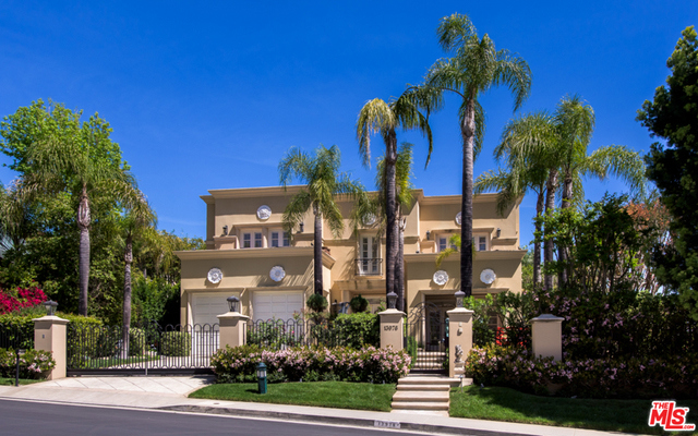 A remarkable villa in prime Mulholland Estates on over half an acre with amazing city views. Entry opens to a double height hall with travertine floors, a wood-paneled library with a custom built-in bookshelf, a living room with fireplace and opens to a covered loggia. The oversized entertainment room features floor-to-ceiling French doors, a world-class A/V projection system, drop-down screen and wet bar. The kitchen has granite counters, a large center island, Dacor 6 burner gas range and 2 convection ovens. Upstairs is a privately positioned master suite with gorgeous views, his/hers baths with walk-in dressing rooms, steam shower, sauna and soaking tub. Three additional upstairs bedrooms with walk-in closets and en-suite bathrooms. Both an upstairs laundry room and a laundry room in the basement adjacent to the maids' rooms. Adjoining lot, of approx. 24,681 sq.ft. APN # 2272-032-044 was sold with the property for $3,300,000.