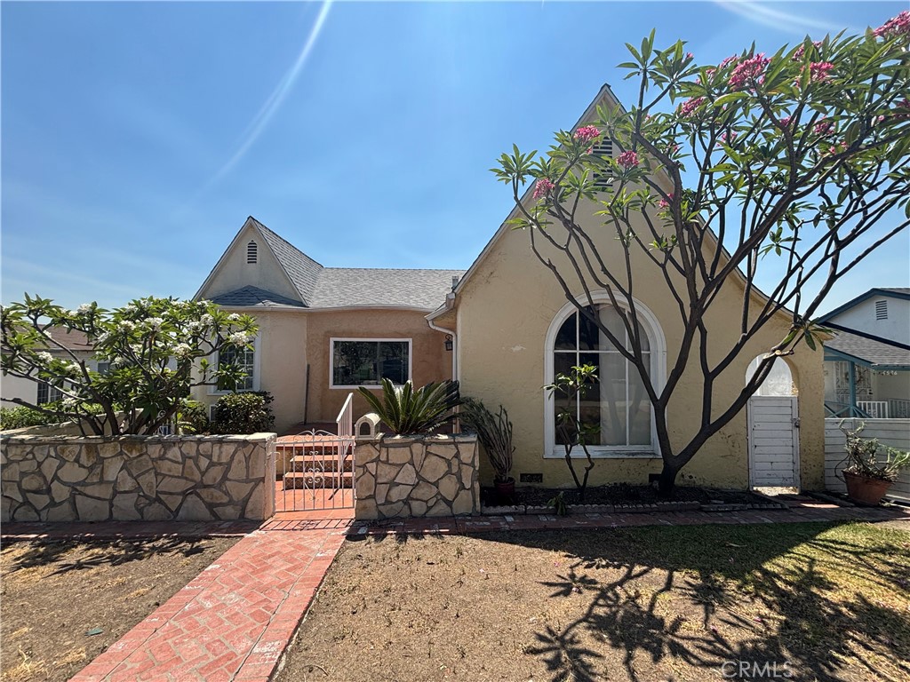 Charming Storybook Tudor Revival in a prime El Sereno location! This character-filled home features stunning views of surrounding hillside, arched ceilings in the living room, a beautiful arched picture window, and a cozy stone fireplace. The formal dining room offers an elegant space for gatherings, while the galley kitchen boasts vintage tile counters and abundant natural light. Downstairs, a spacious den with a stone-accented bar is perfect for entertaining. An upstairs bedroom shows a large patio deck with sweeping views—ideal for enjoying sunsets. While this property is a fixer, it offers incredible potential to restore its architectural charm and create your dream home. With its unique character, expansive layout, and desirable location, this is a rare opportunity for those with vision. In the Red Hot area of El Sereno close to Downtown Los Angeles, USC Norris Medical Center, Rose Bowl and Dodger Stadium this is a great central location for everything. With similar houses in the area going over one million this is a great potential.