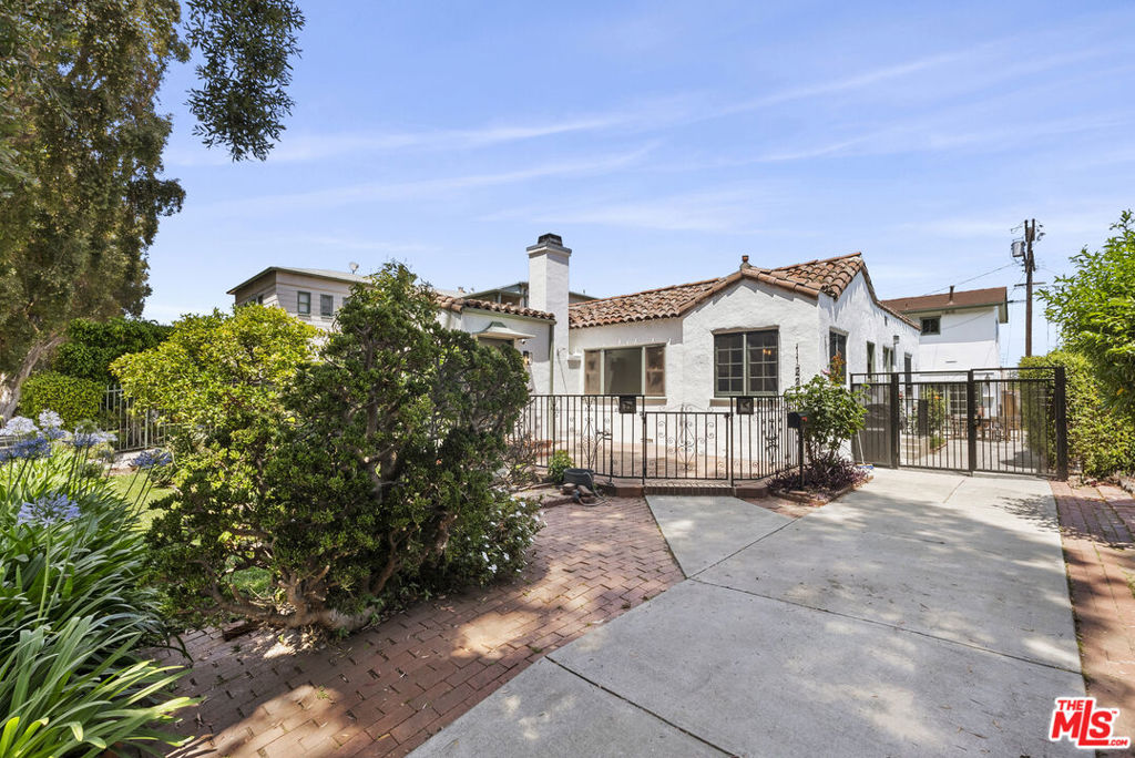 Charming Remodeled 1920s California Spanish Home with Detached Guest House. First Time on the Market in 50 Years this exquisitely updated 3-bedroom, 2-bathroom Spanish-style home offers the perfect blend of timeless charm and modern luxury. Situated in a prime location, just steps from Beverly Hills, Robertson Blvd., and a variety of award-winning restaurants, this home is also in the prestigious Canfield Elementary School District (10), making it an ideal choice for families. The main house features a brand-new kitchen, a chef's dream with sleek quartz countertops, custom wood paneling, and top-of-the-line appliances, including a new stove and washer/dryer. The luxurious primary bathroom offers a dual vanity with ample storage and a stylish shower/tub combo for a spa-like experience. The cozy living room is perfect for relaxing, complete with a gas-burning fireplace, original stained glass windows, and warm peg-and-groove floors that radiate classic Spanish character. New light features, including recessed lighting and contemporary fixtures, highlight the home's elegant design. Step outside to enjoy the beautifully landscaped backyard, complete with a built-in BBQ, perfect for al fresco dining or hosting friends and family amidst mature fruit trees and a serene rose garden. The gated side entrance ensures added privacy and security. The detached two-story guest house is an entertainer's dream, offering ample space with a dedicated entertainment room and French doors that open to the lush yard. The guest quarters also include a full bathroom, kitchen, and additional space for a washer/dryer and storage ideal for guests or family. Additional features of this remarkable home include a new AC and heating system for year-round comfort, solar panels for energy efficiency, and eco-conscious living. This stunning property is a rare opportunity - first time on the market in 50 years so don't miss your chance to live in a piece of history in one of Los Angeles' most desirable neighborhoods.
