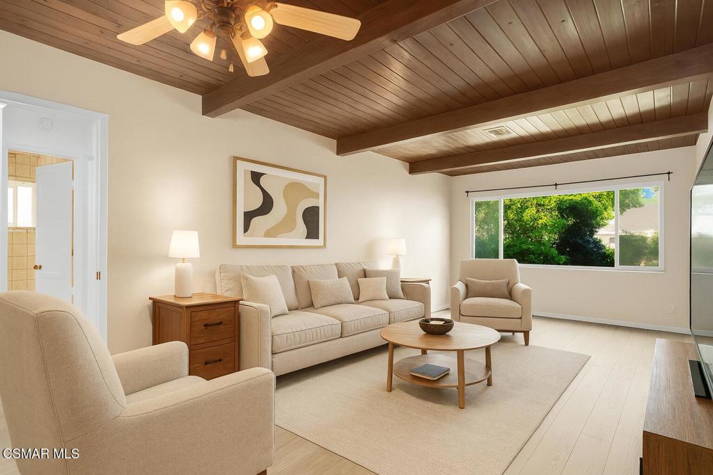 Boasting nearly 1,300 sq ft of well-utilized living space, this home combines timeless vintage details with warm and welcoming touches. Inside, each room is highlighted by beautiful wood-beam ceilings, and ample windows that flood the space with natural light. The adjacent kitchen opens to a dedicated dining area and features a charming breakfast bar peninsula that adds function and flow for everyday living and entertaining.The private backyard features mature landscaping, fruit-bearing grapefruit and orange trees, a tranquil pond, and space for a garden, play area, or pool. An automatic retractable awning offers shade, and a charming covered front porch adds to the home's curb appeal.The home's three-bedroom floor plan is currently configured as a two bedroom with an expansive primary suite. If you're looking for that defined third bedroom, do not overlook the opportunity to easily restore the space back into a 3rd bedroom. You'll love the move-in readiness the home offers. Both bathrooms have been tastefully updated, and the primary bathroom offers direct access to the backyard--ideal for future pool plans, guests, or outdoor living ease.Additional upgrades and move in features include central air conditioning, dual pane windows and OWNED SOLAR panels for long term energy efficiency.Bordering Van Nuys and Lake Balboa and just minutes from parks, shopping, and the 405 freeway, this location offers the perfect balance of suburban tranquility and commuter convenience.Some photos have been virtually staged to help envision how the space can be used!
