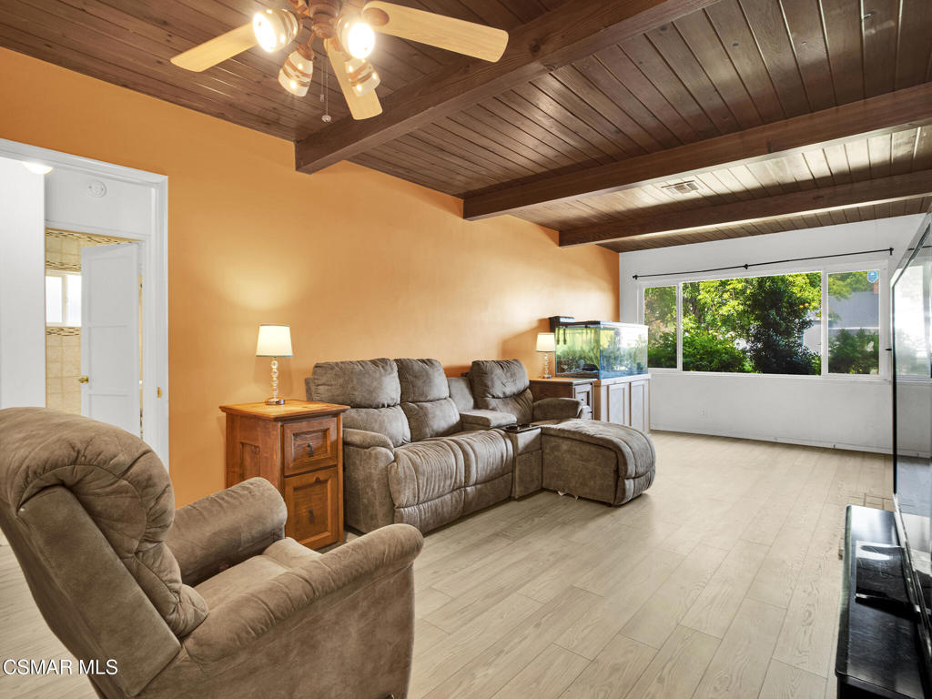 Nestled on a peaceful, tree-lined street in one of the Valley's most sought-after neighborhoods, this inviting Lake Balboa gem offers the perfect blend of character, opportunity, and a great locale.With nearly 1,300 sq ft of well-utilized living space, this home combines timeless vintage details with thoughtful modern upgrades. Originally a 3-bedroom, the home is currently configured as an expansive 2-bedroom with a generous primary suite. If you're looking for that extra space... do not overlook the opportunity to convert back into a 3-bedroom home!Inside, you'll find a warm and welcoming living room highlighted by beautiful wood-beam ceilings, a cozy fireplace, and large windows that flood the space with natural light. The adjacent kitchen opens to a dedicated dining area and features a charming breakfast bar peninsula that adds function and flow for everyday living and entertaining.Both bathrooms have been tastefully updated with modern finishes, and the primary bathroom offers direct access to the backyard--perfect for future pool plans, guests, or outdoor living ease.The backyard is a peaceful escape with mature landscaping, fruit-bearing grapefruit and orange trees, a tranquil pond, and plenty of space to relax or play. An automatic retractable awning provides shade and comfort for sunny afternoons, and the covered front porch adds to the home's charm. Bordering Van Nuys and Lake Balboa and just minutes from parks, shopping, and the 405 freeway, this location offers the perfect balance of suburban tranquility and commuter convenience. A fantastic opportunity in a prime location.