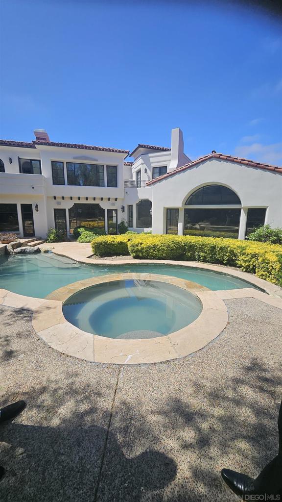 This luxury home located in the prestigious community of The Bridges in Rancho Santa Fe, CA. As you enter the gated community, you will be greeted by the grandeur of this residence. The house features a pool with a view of the golf course. The outdoor fireplace and grill create an ideal setting for entertaining guests or simply enjoying a quiet evening under the stars. Inside, you will be captivated by the vaulted ceilings and large skylight, allowing natural light to flood the living spaces.