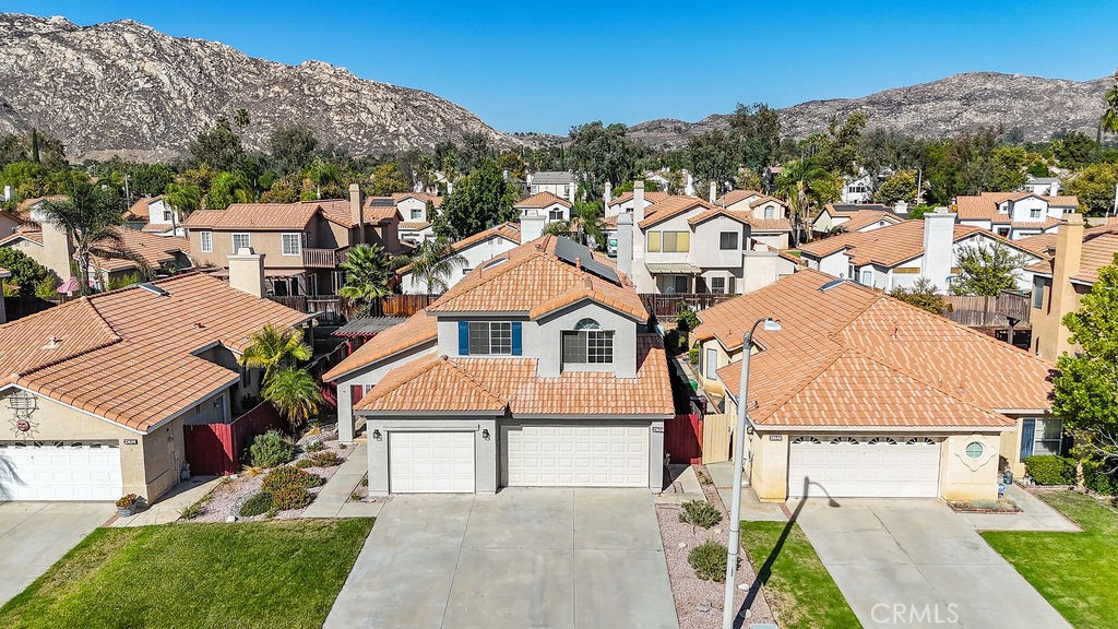 WELCOME HOME to Sunnymead Ranch! This stunning 5-bedroom, 3-bathroom residence is nestled in the highly sought-after community of Moreno Valley. From the moment you arrive, you’ll notice the freshly painted exterior, beautifully updated landscaping, and spacious 3-car garage. Step through the double doors into a bright, airy home with soaring ceilings and abundant natural light. The formal living and dining areas feature brand new Luxury Vinyl Plank flooring and fresh interior paint, creating a modern and inviting atmosphere. The heart of the home is the fully remodeled kitchen, showcasing new cabinets, quartz countertops, stainless steel appliances, and a farmhouse sink. A cozy breakfast nook flows seamlessly into the family room, complete with a charming fireplace—perfect for gatherings. Downstairs, you’ll find a private bedroom and remodeled full bath with a new vanity, ideal for guests or multigenerational living. Upstairs, a spacious loft provides extra living space, flanked by three bedrooms. The primary suite offers tranquil views of the backyard and a beautifully updated bathroom with a new vanity, making it the perfect retreat. The backyard is designed for relaxation and entertainment, featuring a serene pond with the soothing sound of running water and ample space for outdoor dining. This home is energy efficient with dual A/C units and solar panels that the buyer will need to take over payments on. As a resident of Sunnymead Ranch, you’ll enjoy resort-style amenities including a private lake, pool and spa, sports courts, parks, and picnic areas. Don’t miss the chance to call this move-in ready home yours! SCHEDULE YOUR PRIVATE SHOWING TODAY!