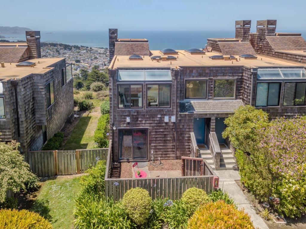 Stunning End-Unit Townhouse with Panoramic Ocean Views with 2 Pools (Indoors and Outdoor Pools) If you're searching for a Truly Exceptional Ocean View, this is one of the best in a community known for wonderful ocean views. From your couch, gaze all the way south to Pedro Point, beyond the Pacifica Pier sweeping, unobstructed coastal panorama that's rare to find. This bright and airy end-unit townhouse is filled with natural light, thanks to walls of windows and multiple skylights. Enjoy morning coffee or evening cocktails from three private outdoor spaces, each offering a different perspective of the ocean and surrounding beauty. On the first level, find 2 spacious bedrooms, 2.5 bathrooms, and 1,440 square feet of thoughtfully designed living space. The top is an open-concept living and dining area features elegant flooring, a cozy fireplace, and effortless flows and ideal for everyday living or entertaining. The well-appointed kitchen is ready for casual meals or special dinners. A dedicated laundry area adds daily convenience, while the oversized 2-car garage offers generous storage and parking. Community amenities include indoor and outdoor pools, perfect for year-round enjoyment.