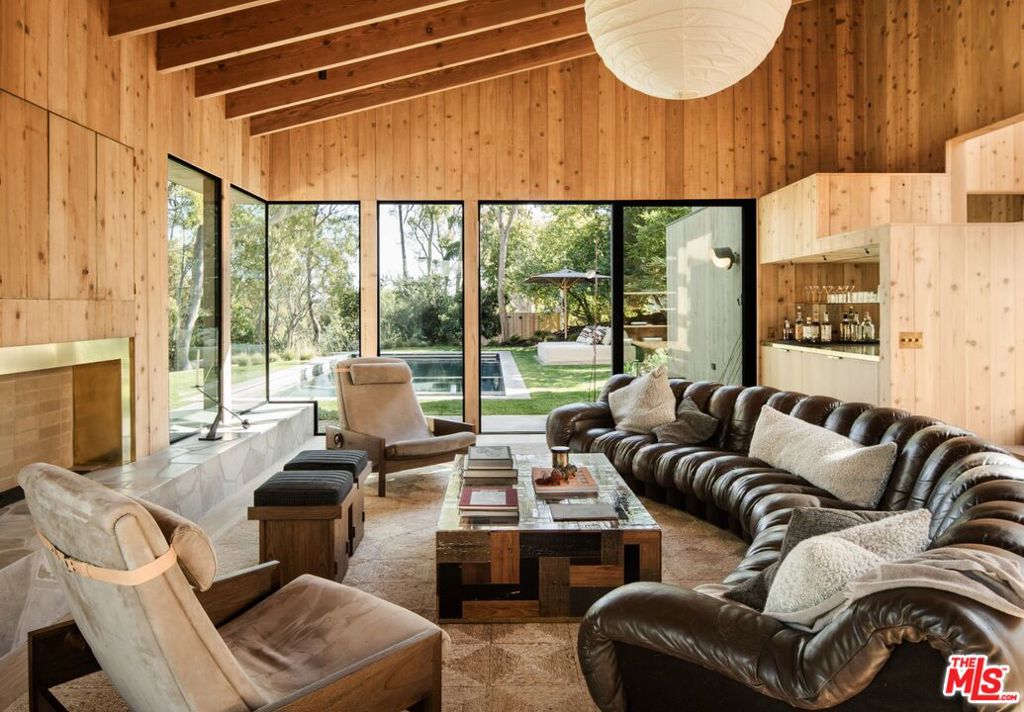 Completely reimagined post-and-beam home set on the only gated street in the exclusive Point Dume neighborhood of Malibu. Originally designed by renowned architect Ronald Goldman, FAIA in 1979, the home went through a meticulous 3-year "down-to the-studs" renovation by Alexander Design in collaboration with Alexander Built Properties. The 5-bedroom, 4-bathroom residence seamlessly blends the light filled warmth of post-and-beam architecture with modern luxury. The redesign honors Goldman's commitment to sustainability with drought-tolerant landscaping, cross-ventilation, and skylit hallways that flood the home with natural light. Inside, the home features custom cabinetry, millwork, and brass detailing by Alexander Design, alongside elegant custom stonework, door hardware, Fleetwood doors and windows, Gaggenau appliances, and Cocoon Piet Boom plumbing fixtures. Thoughtfully curated interiors include a blend of custom and collectible vintage furnishings that exude timeless sophistication. The latest and greatest amenities include a new saltwater pool, a pizza oven, a Sonos sound system, and heated bathroom floors. Nestled on a private cul-de-sac, the property also provides an access key to the exclusive Little Dume beach and a shared tennis court. This one-of-a-kind estate captures the essence of Malibu's effortless elegance, offering an unrivaled lifestyle of luxury and coastal serenity.