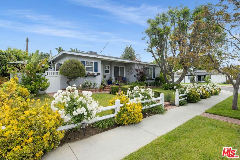 THIS HOME QUALIFIES FOR A SPECIAL LOAN PROGRAM OFFERING BELOW 6% INTEREST RATE BASED ON ZIP CODE! Located on a large, desirable corner lot in one of Lake Balboa's most sought-after pockets, this beautifully maintained home offers outstanding curb appeal with mature rose bushes and a classic ranch-style wood fence. Inside, a warm and welcoming entry features elegant wainscoting, leading to a thoughtfully updated kitchen with quartz countertops, Thermador and Samsung stainless steel appliances, and custom solid wood cabinetry. The spacious living and dining area showcases pristine original hardwood floors, a cozy fireplace, and sliding glass doors that open to a tranquil backyard retreat. The oversized primary bedroom offers a serene escape, while two additional secondary bedrooms, one with an en-suite half bath, provide comfort and versatility. Both bathrooms have been tastefully renovated. Perfect for entertaining, the enchanting backyard includes a covered patio, jacuzzi, expansive decking, BBQ island, and a gazebo. A detached two-car garage, ideally situated on the lot, presents excellent ADU potential (buyer to verify). Most systems in the home have been recently updated, adding to its long-term value. Encino-adjacent and moments from Lake Balboa Park, the Sepulveda Basin Dog Park, Japanese Gardens, and the Encino Farmers Market, with easy access to the 101 and 405 freeways, this home is a true pride-of-ownership gem and is sure to be the envy of the neighborhood.