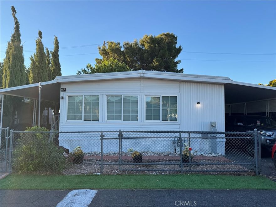 Curb appeal includes humongous no maintenance yard with artificial grass and large trees maintained by park owner and watered with set sprinkler system ) the yard is completely fenced in with only one lovely neighbor to the left..so much privacy!! large porch is protected by huge new roof and huge carport on the right!large shed is included! new wood like laminate has been installed 2 years ago and matches throughout.freshly painted. the living room is very very large and includes 75 inch flat screen above an electric fireplace- it boasts an interchangeable couch that can be configured any way. the dining room is open and airy with so much storage space in the built in cabinets! the kitchen was completely redone and has new stainless appliances and top of the line dishwasher and deep wide sink! the fridge has built in ice maker! extra counter space was created for coffee nook or bar – gas washer dryer is new- the pantry is so big! The counters were custom made to look like real stone! The master bedroom could really be two bdrms cuz its so big and has so much storage and hand made closets! It fits a king size bed on an adjustable frame! The 2nd bdrm has two queen beds and lots of cube storage-both bdrms have large tvs and desks-the house is so comfy for a small family and has central ac and heat which were well maintained!!! The jacks underneath are not very old and are in great condition!! The community is quiet and makes you feel safe and only 35 minutes from big bear!! Apple valley HS and Alta vista learning center are only 5 mins away!