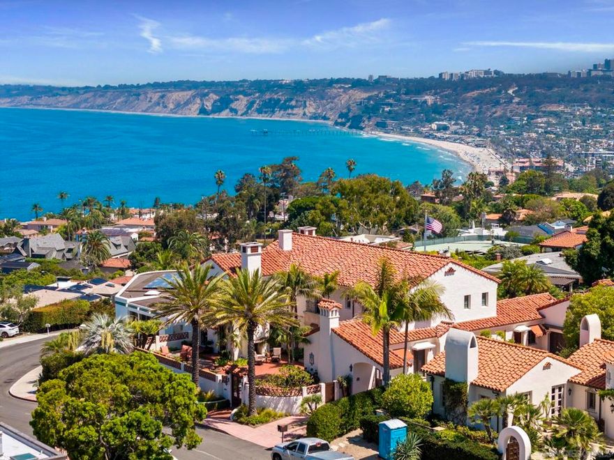 From fairway to sea, this magnificent Spanish Revival residence by esteemed Trip Bennett, AIA celebrates its rare ocean-view site on the lush greens of La Jolla Country Club. Richly crafted details and timeless design align perfectly with La Jolla's history and sweeping panoramas of the Pacific, offering a gracious environment for a lifestyle both refined and relaxed. On one of La Jolla's most sought-after and friendly Country Club streets walkable to the village, a lovely, private gated courtyard with fireplace and water fountain invites guests into a voluminous two-story entry foyer with leaded clerestory window and dramatic curved staircase to the upper level. Distinct interior living includes living and dining areas with two-sided fireplace and tray ceilings, a fantastic kitchen with spectacular butler's pantry with walls of china cabinetry, opening to breakfast nook and family room area with wood beam ceilings and French doors to expansive back patios on the golf course. The back patio includes a built-in barbecue area, water feature, and a beautiful guest house with Spanish tile steps to a rooftop terrace with mind-blowing panoramic ocean and coastline views.  The primary bedroom suite with fireplace offers balconies with endless ocean, village and coastline views and an exquisite bathroom. One might work night and day in the office with box beam ceilings and the same incredible ocean views... We cannot say enough about this wonderful property, representing an exceptionally rare combination of features that, together, create the perfect home for La Jolla living.