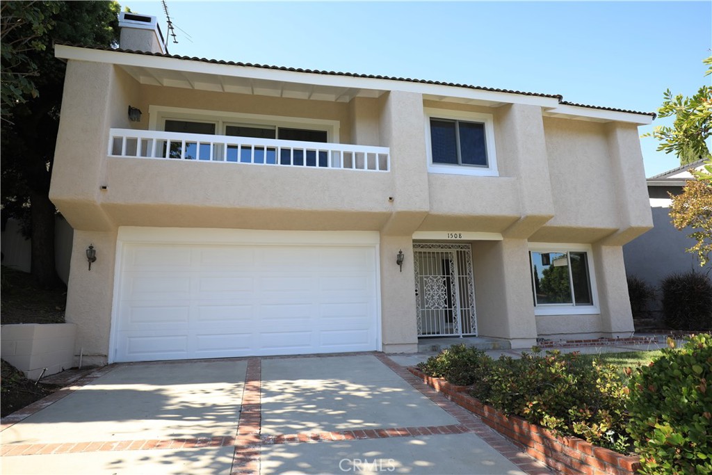 This is the first time on the market since it was purchased by the original owner in 1976! Discover the perfect balance of style, space, and function in this wonderful split-level home. The living room, bedrooms, and kitchen are all upstairs with the garage and large office downstairs, ideally situated for a more secluded workspace when coming-and-going, taking calls, or meetings. The office can easily double as a guest room, hobby space, or even a playroom, offering flexibility as your needs evolve. The master bedroom has high vaulted ceilings, a spacious walk-in closet, and private ensuite bathroom. One of the standout features of this home is the brand new white oak laminate flooring. It combines the warm, natural beauty of white oak with the durability and easy maintenance of laminate, offering the perfect balance of style and practicality. As you move into the kitchen, you’re greeted by beautiful cabinetry that doesn’t just store your essentials, they elevate the entire space with timeless beauty and craftsmanship that speaks to the quality and care that was put into this home. Unleash your inner master chef with the Wolf six-burner vented range and in the center of the kitchen, you have a spacious island with outlets on both sides and a lovely built-in wine rack. The dual pane windows throughout the home help to effortlessly maintain your desired temperature year-round. Turn on the A/C or heat at the touch of a button or cozy up next to the wood burning fireplace on those chilly nights. This ideal lot has it all with shade from the willow tree, a large flat grass area, and a cement area for outdoor furniture, BBQ, and entertaining. It even has a bit of an ocean and port view!