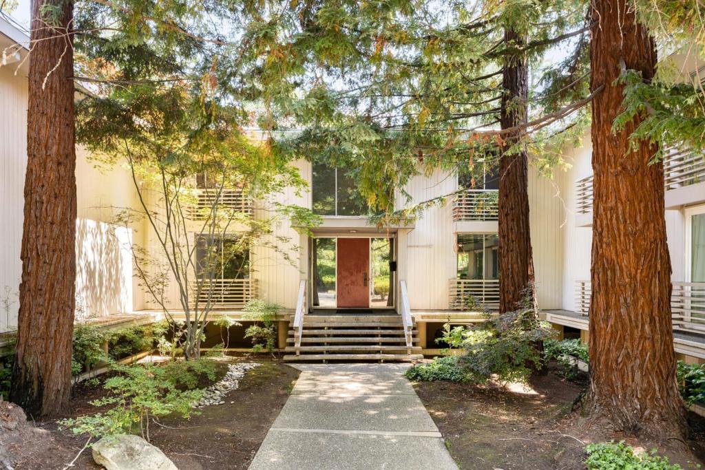 Nestled behind the gates in one of Menlo Park's highly coveted enclaves adjacent to Sharon Heights Country Club, this beautifully updated, ground-level unit offers a perfect blend of modern comfort & tranquil living. This corner unit with an open floor plan features a formal entry and a spacious living/dining area. Surrounded by floor-to-ceiling windows & glass doors that lead to private balconies with picturesque views of the mature redwoods and surrounding landscape. With an eat-in kitchen, two generously sized bedrooms - each featuring large closets including a walk-in in the luxurious primary suite. Outside, indulge in the luxury of a heated pool. Additional amenities include two covered parking spaces, a community laundry, with option to convert the large hall closet into a private laundry, as other units have successfully done, and a large storage unit just across the hall. This residence offers a tranquil setting while being just moments away from 280, Stanford, local parks & hiking trails & the vibrant shopping & dining options at Sharon Heights Shopping Center, downtown Menlo Park & Palo Alto. Las Lomitas Schools.