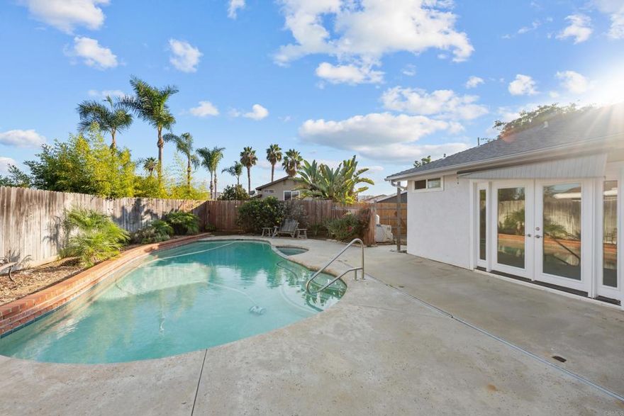 Impressive Single story pool  home with 4 bedrooms, 2 bathrooms, 1,634 sq ft, on a 8,429 sq ft lot. New heating and water heater in 2021! Owner recently updated the home with new interior doors, paint, carpeting, lighting, electrical switches/plates, new stainless steel oven, new hall bath shower, new baseboards, updated hinges/doorknobs, and new casings! The floor plan is incredibly spacious with a huge kitchen featuring butcher block island, a mass amount of cabinetry, under cabinet lighting, huge storage hutch with lighting,  garden window, gas cooktop, open to large dining room area and conveniently located by the garage. The windows are are vinyl dual pane windows with 3 large french doors from kitchen/living/primary rooms inviting all of the natural light and view to heated pool/backyard! The living room has a gas/wood burning fireplace and vaulted ceilings. The oversized 2 car garage parks 2 cars easily with room for storage. This area is tucked away and feels far away from the city but is minutes to Target/Trader Joes shopping center and to 78! Also only 6 minutes to popular downtown Vista! Enjoy plenty of street parking for guests, NO HOA, Cul-de-Sac street great for kids and close to Hannalei Elementary school. Vista is truly an exceptional city in San Diego County!