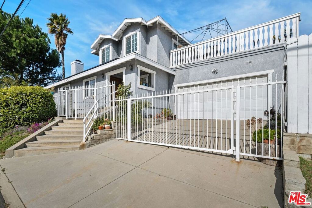 Nestled in the tranquil foothills of Sylmar, this charming 2-story home on a desirable corner lot offers the perfect blend of comfort, privacy, and functionality. Designed with family living in mind, the home features two primary suites, one upstairs and one downstairs, along with two additional bedrooms and full bathroom in the hallway, providing ample space for families of all sizes. The upstairs primary suite is a true retreat, complete with a spacious private deck that overlooks the serene backyard and surrounding hills, ideal for relaxing and enjoying peaceful views. Entertain guests in the formal dining room or prepare meals in the well-appointed kitchen, featuring beautiful granite countertops, abundant storage, and ample counter space. The cozy living room, highlighted by a welcoming fireplace, adds warmth and charm to the home. In addition to the four bedrooms in the main house, a large bonus suite with its own private entrance, bathroom and kitchen offers excellent potential as a guest suite, extended family residence, or income-generating rental. Currently operated as an Airbnb, this space brings in approximately $1,200 per month, adding valuable income potential to the property. The fully gated lot offers a spacious backyard with multiple fruit trees, a dedicated workspace, and a bonus storage area. A side-by-side laundry area and leased solar panels add further convenience. The expansive driveway with an automated gate provides ample parking for multiple or large vehicles. Ideal for multi-generational families or those seeking both privacy and room for gatherings, this home is conveniently located just minutes from hiking trails, El Cariso Park & golf course, Veterans Memorial Park, Los Angeles Mission College and the 210 freeway. Don't miss the chance to make this beautiful residence your own and experience the best of Sylmar living.
