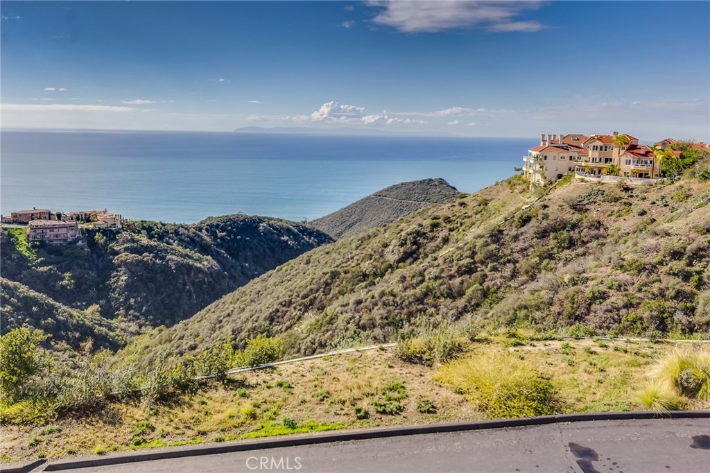 Experience luxury coastal living at its finest in this beautifully remodeled home, ideally situated within the 24-hour guard-gated community of Laguna Sur. Enjoy sweeping, unobstructed views of the Pacific Ocean, Catalina Island, and vibrant sunsets from every level of this stunning residence.
Enter into an elegant open-concept layout adorned with designer finishes, including vaulted cathedral ceilings, skylights, recessed lighting, custom cabinetry, and exquisite ceramic tile flooring throughout. The main level features a gourmet kitchen with stainless steel appliances, a formal dining area, and a spacious living room with a fireplace, perfect for both entertaining and everyday comfort. The primary suite on this level offers a walk-in closet, spa-inspired en-suite bath, and a private balcony where ocean breezes and panoramic views await.
A graceful staircase guides you to the lower level, where you will find a generous secondary living area complete with fireplace and wet bar, a second powder room, and an additional luxurious primary suite with its own en-suite bath. From here, access the covered lower balcony to unwind and take in the serene coastal surroundings in total privacy.
Laguna Sur residents enjoy resort-style amenities including two pools and spas, tennis and pickleball courts, and scenic walking trails. Located minutes from world-renowned beaches, luxury resorts, fine dining, premier golf courses, and upscale shopping, this is more than a home; it’s a lifestyle.