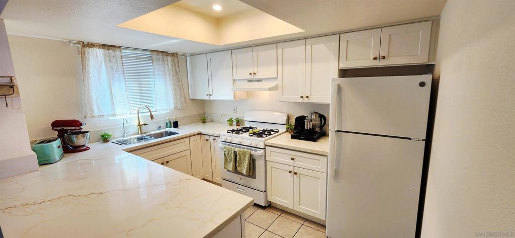 This gorgeously remodeled 2-bedroom, 2-bathroom condo offers the ultimate walkable lifestyle, putting you just a short stroll from your favorite restaurants, shops, and vibrant nightlife. Inside, you'll find an airy upstairs end unit bathed in natural light, with vaulted ceilings creating an expansive and inviting atmosphere. Every detail has been meticulously updated for a truly move-in ready experience. The brand-new kitchen boasts stylish cabinets, sleek countertops, and all-new appliances, while both bathrooms have been completely transformed with modern finishes. Enjoy peace and quiet thanks to new Milgard soundproof dual-pane windows. Throughout the unit, you'll love the elegant new vinyl wood flooring, fresh paint, new baseboards, and new doors. Convenience is key with a washer and dryer inside the unit and your assigned parking spot just steps from your front door. Plus, with a pet-friendly HOA, your furry friends are welcome to enjoy the large private balcony with you. This exceptional condo won't last long—schedule your private showing today! **DOWN PAYMENT ASSISTANCE AVAILABLE**