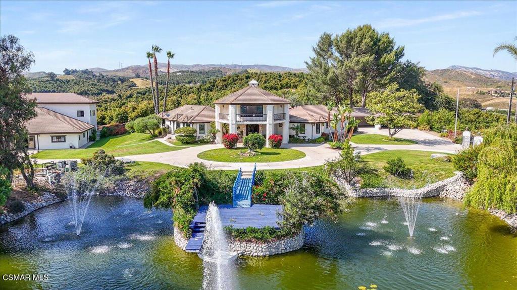 Hilltop Estate with Breathtaking 360 Views!
Enjoy panoramic views of the ocean, Channel Islands, and surrounding mountains from this extraordinary hilltop property. Spanning two side-by-side parcels, this private estate offers endless possibilities. The main residence with 3 bedrooms is thoughtfully designed for indoor-outdoor living. You will be whisked away as soon as you walk through the double front doors into the grand Tuscan great room boasting soaring ceilings open to the second story and two sets of floor-to-ceiling French doors and windows with the royal fireplace centered in-between, opening to the pool area and bathing the space in natural light. A separate media room with a luxurious wood built-in wall unit and French doors facing the pool provides an elegant space to relax or entertain, with a half bath offering direct access to the pool and spa area. A spacious kitchen overlooking your private pond features a movable island, endless counter space, sitting bar plus eat-in area, and a dishwasher, while the connected laundry room includes a sink, counter space, cabinetry, and a walk-in pantry. A powder room is conveniently located right off the kitchen and dining for your guests.Nearly every room has doors leading outside, all adorned with plantation shutters as well as the windows. The ground-level primary suite offers a spa-like retreat with a soaking tub, walk-in shower, and an expansive cedar-lined walk-in closet. Additional features include a formal dining room, a guest bedroom with a Murphy bed, and a luxurious, upstairs office/library with rolling ladder, hidden half bath, and a wrap around balcony overlooking the koi pond and views in all directions. You will feel like royalty in your palace. *** Outdoor highlights include a sparkling pool and spa, gazebo, built-in BBQ into the chimney (designed for easy conversion to a pizza oven), and a free-standing, tree-shaded relaxation deck for morning coffee with the sounds of birds chirping or afternoon breezes.... Do I sense a nap headed your way? The impressive 8-ft-deep koi pond features a waterfall, spouting fountains, a bridge leading to the deck, and even a rowboat.The second structure includes: ** A wine tasting room with temperature-controlled wine storage for hundreds of bottles, sink, dishwasher, and mini fridge **Two oversized upstairs rooms with stunning views and deck access facing the islands ** A fully equipped ADU with kitchen, living room, walk-in closet, more storage closets, and separate bedroom ** A 'barn' space with tool/equipment rooms. The main portion of the barn centered in the building and open to the second level is a partially constructed sound studio with in-floor channeling for wiring--ideal for music, events, or expanded wine tasting with French doors leading outside to more flat, concrete space to entertain. Additional amenities include a 4-6 carport (one bay is extra deep for storage or more parking), a private helicopter pad, various fruit trees, and approximately 7 acres of avocado groves--previously maintained as a hobby farm, but with potential for commercial production.This is a rare opportunity to own a truly one-of-a-kind estate with commanding views, exceptional amenities, and versatile space for entertaining, relaxing, or working from home. ** Main house is 3 beds, office/library, two full baths, 3 half baths 3,917 sqft. ** Living area = main house + ADU 450 is 4,367 sqft. ** 2nd Structure is ADU with 1 bath (450 sqft) Wine Room, craft room(?) Barn/tools/equipment rooms, two large rooms upstairs with deck is 4,267 sqft. ** Sale includes TWO parcels: APN 502-0-080-065 (7.80 acres) and APN 502-0-080-095 (2.27 acres).