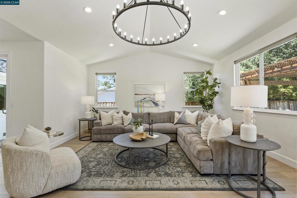 This single-story, white rancher has been updated & expanded to include the ultimate Great Room. Think Pottery Barn charm with an amazing flat backyard featuring hillside views, nature & open space with no rear neighbors. Private & tranquil. Room for everyone and everything ~ imagine a pool, outdoor kitchen or ADU. Enjoy the putting green, redwood pergola, sports court and expansive low-maintenance turf. Kitchen & baths have been fully remodeled with all the on-trend finishes for today's discerning buyers. White kitchen offers Thermador stainless appliances, slab countertops, subway tile backsplash & island with seating. Additional bar with wine refrigerator & open shelving. Perfect for entertaining and everyday living. Wide planked hardwood floors, Milgard windows & sliders throughout. Great curb appeal as the front of the home was fully renovated in 2024 with the addition of a front porch, stone accents, new roof & roof line, new siding & new front door. New landscaping in 2025 includes stone wall, new steps & pathway to the front door plus new plantings. Simply darling and turn-key in a revitalized neighborhood located near 13 years of top schools & close to downtown Danville. Great sense of community and truly a wonderful place to call HOME.