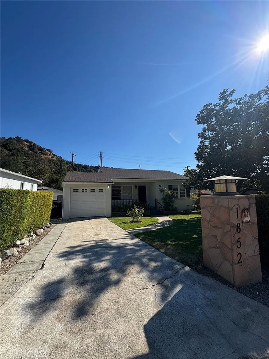 Welcome to 1852 Alpha Rd, a beautifully remodeled cottage in Glendale's highly sought-after Verdugo Woodlands. This charming home features new laminate floors, classic wood windows that fill the space with natural light, and an oversized kitchen with granite countertops, tile flooring, and a wall of glass opening to a romantic covered patio with serene views. Offering two spacious bedrooms plus a versatile den that can serve as a third bedroom or office, the home also includes a full bath and a private primary bath. The private backyard is a true retreat with a lush lawn, mature trees, and garden areas, perfect for entertaining or relaxing outdoors. Additional highlights include central air and heating, an attached garage, laundry area, and extra storage. Situated in one of Glendale's most desirable areas, this home combines peaceful living with convenient access to shopping, dining, freeways, and top-rated schools including Fremont Elementary, Rosemont Middle, and Crescenta Valley High.