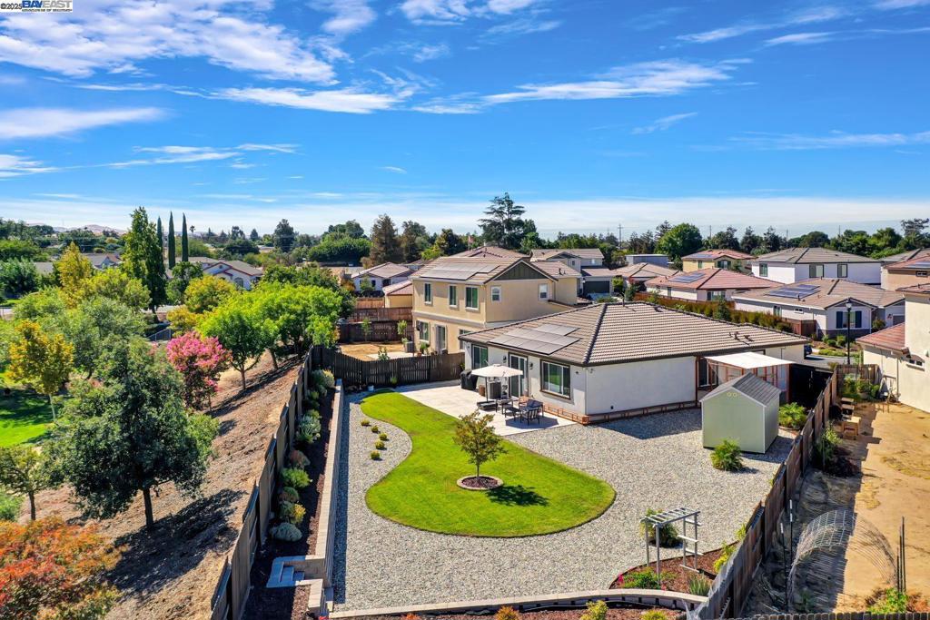 Spectacular 4-year “new” Meritage home on a premium 9,000+ sq.ft lot with no rear neighbors in the gated “Vines” community! This 3 bed/2 bath, 1,630 sq.ft home showcases nearly $75K in upgrades and an open, light-filled floorplan. A versatile guest/multi-purpose room features custom cabinetry, shelving, and LVP flooring, with a full bath nearby. The second guest room includes custom paint and built-ins, plus a convenient touch-down desk area. The upgraded laundry room adds custom cabinetry, shelving, and backsplash. The expansive great room highlights a stunning kitchen with espresso cabinets, granite counters, stainless appliances, and modern lighting, flowing into a spacious family and dining room with tile flooring and custom draperies. The owner’s suite offers upgraded LVP, custom draperies, a large walk-in closet, and spa-like bath with dual sinks, Roman tub, and step-in shower. Energy-efficient with owned solar, tankless water heater & 2-car garage with storage. The backyard steals the show with a custom patio, premium shed, retaining wall, and “Catio”! Perfect for relaxing or entertaining, this home truly feels like a model—combining comfort, elegance & convenience, just minutes to Hwy 4/80, Costco, Sprouts & The Streets of Brentwood.