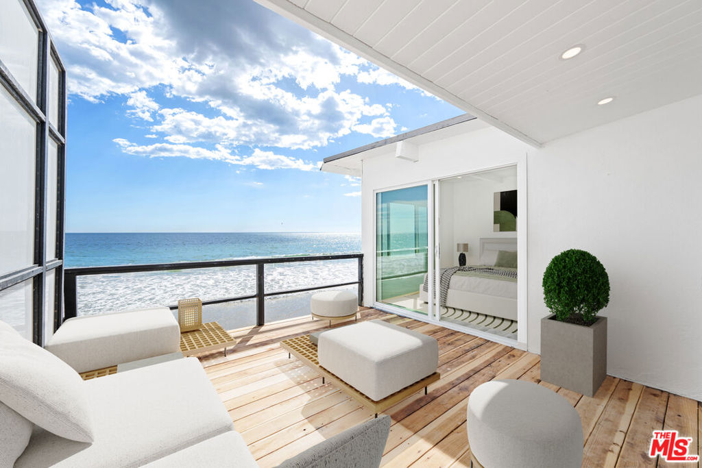 Beachfront Bliss on Malibu Road. Welcome to your dream coastal escape on one of Malibu's most sought-after streets! This beautifully remodeled 2bed/2bath beachfront unit offers an effortless blend of modern comfort and laid-back coastal chic, nestled in an intimate four-unit building right on the sand. Step into a bright, airy living space where sliding glass doors frame sweeping ocean views and natural light pours in from every angle. The updated contemporary kitchen features new appliances, stylish countertops, and a seamless flow into the open-concept living and dining area complete with a cozy fireplace that sets the mood for sunset evenings. Slide open the glass doors to your private beachfront deck, an ideal setting for morning coffee, al fresco dinners, or simply soaking in the sound of the waves. Keep an eye out for dolphins playing in the surf - this is Malibu living at its finest. Both bedrooms have updated bathrooms and serene coastal vibes. The unit includes a one-car garage plus an additional tandem parking space, along with direct access to the sand just steps from your door. Located minutes from Malibu's best dining, shopping, and entertainment, this rare gem offers a blend of convenience and seclusion. Live where every day feels like a vacation-relaxing, revitalizing, and surrounded by the beauty of the Pacific.