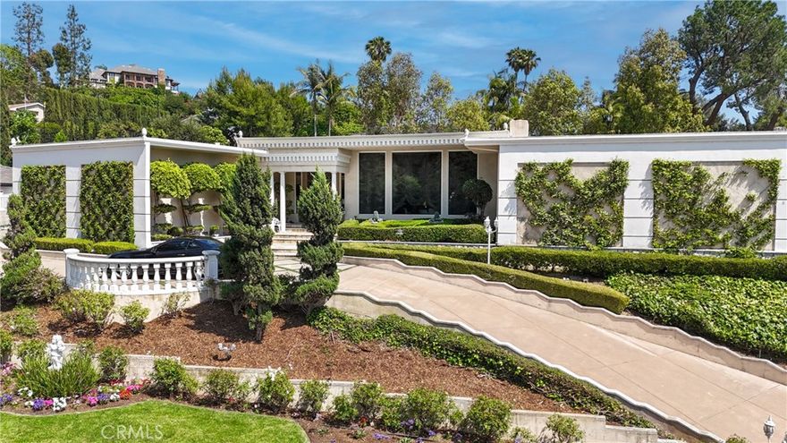 Welcome to a rare opportunity in the prestigious Friendly Hills neighborhood of Whittier. This expansive 6,313 square foot estate blends the timeless elegance of Hollywood Regency and Neoclassical Revival architecture with tasteful modernist influences. Featuring four spacious bedrooms, six bathrooms, an expansive pool, and a separate pool house with its own bathroom, this home offers both grandeur and versatility. Just a few steps down from the main level, a generously sized great room awaits—complete with a full wet bar and its own bathroom—perfect for entertaining, relaxing, or hosting in style.



Set on a picturesque, tree-lined street with wide lawns and lush landscaping, the setting feels straight out of a movie. Friendly Hills is known for its charm and character, where no two homes are alike. You’ll find everything from Mediterranean and Craftsman to midcentury ranch and contemporary styles, creating a custom-home community that’s as unique as it is welcoming.



Inside, marble floors grace the entrance of the main living area and Swarovski crystal chandeliers glisten and mesmerize throughout, setting a tone of luxury and warmth. The gourmet kitchen is a true centerpiece, appointed with sleek marble countertops, a marble stone backsplash, and top-of-the-line appliances including a Sub-Zero refrigerator and freezer, induction cooktop, gas range, dual ovens, steamer, deep fryer, and built-in icemaker—everything you need to host on any scale.



Two garages—one side-by-side two-car and another tandem two-car—both provide direct access into the home for convenience and security. Every corner of this estate is designed for effortless living, with soaring ceilings, rich textures, and elegant architectural details that reflect the glamour of Old Hollywood while offering all the function of modern design.



Outdoors, the private backyard serves as a resort-style retreat with a sparkling pool, spa, and beautifully manicured grounds. The fully equipped pool house adds exceptional flexibility, ideal for guests, a home office, or creative studio.



Adding even more value, the home is located within the highly rated boundaries of Murphy Ranch Elementary, Granada Middle School, and La Serna High School—each known for academic excellence and community involvement.



This is more than just a home—it’s a legacy property in one of Whittier’s most desirable neighborhoods, offering beauty, function, and an unmatched lifestyle.