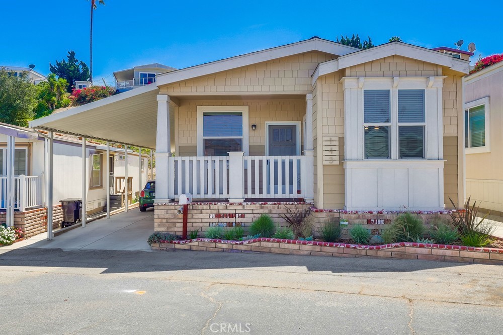 Welcome to 2550 Pacific Coast #143, a spectacular Craftsman-style 2-bedroom, 2-bathroom 1,200 square feet designer home in the Skyline Mobile Community! Charming newer 2019 build turnkey home is located on a quiet walk street. Open & airy home offers a sense of tranquility & ease featuring sunrises & sunsets, multiple outdoor seating areas, low maintenance yard, central A/C & heat, dual pane windows, 9-feet high ceilings, laminate floors, ceiling fans, custom blinds & crown molding. As you enter the home you walk into the spacious living room boasting natural light, high ceilings, recessed lights, laminate floors, ceiling fan & custom blinds. Kitchen opens to the living room & dining area. Kitchen is well equipped w/island, storage & shelving, 3-seat breakfast bar, recessed lights, farmhouse sink, stainless steel appliances including gas stove, oven, fridge (w/built-in ice maker/water), microwave, dishwasher, tile backsplash, butternut shaker hardwood cabinets, plentiful countertop space, custom blinds & laminate floors. Cozy dining area stuns w/exquisite chandelier, laminate floors & 3 windows pouring in natural light. Primary bedroom features massive closet, new carpet, ceiling fan, natural light, high ceilings, recessed lights & bathroom ensuite. Primary bathroom showcases soaking tub, walk-in shower, laminate tile floors, dual sink vanity, Quartz countertops, butternut hardwood cabinets & linen closet. Guest bedroom is the perfect size to convert to an office & home gym! Guest bedroom offers plentiful closet space, ceiling fan, laminate floors, custom blinds & exquisite wallpaper. Guest bathroom has a tub/shower combo, single sink vanity, butternut hardwood cabinets, Quartz countertops, recessed lights, medicine cabinet & laminate tile floors. Laundry room comes fully equipped w/washer & dryer, cabinets for storage & pet door. Exterior home offers quaint Trex deck w/brick skirting & garden planter, low maintenance landscaping & spacious back patio/terrace. Carport fits 3 cars on newer concrete driveway. Property taxes are ~$1,400/yr. Home located in excellent school district & near Whole Foods, Trader Joe’s, Starbucks, movie theater, restaurants, hospitals, freeway & beaches. Community boasts amenities including security guard gate, community rec center, pool, hot tub, BBQ, billiards, shuffleboard, kitchen, darts, putting green & on-site manager. Monthly events include movies, water aerobics, yoga, poker, line dance, karaoke, guitar, tai chi & Bingo.