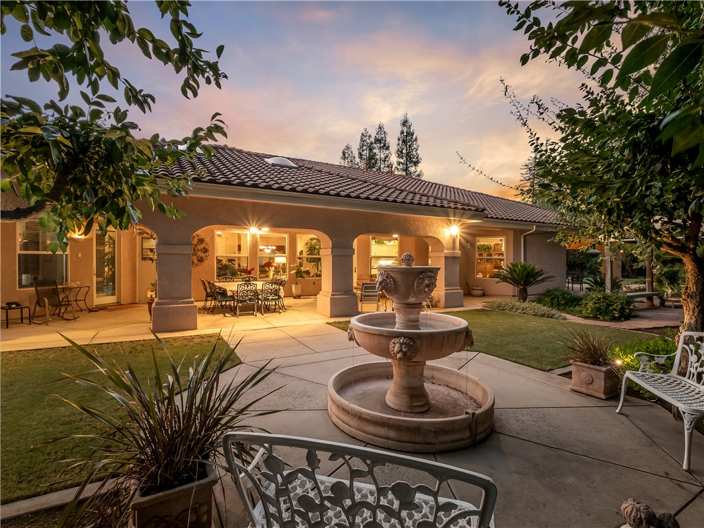 Experience timeless luxury in this exquisite custom estate, nestled in the prestigious St. Catherine Ct community just off the iconic Van Ness Boulevard. Set on over half an acre of meticulously landscaped grounds, this residence displays elegance, sophistication, and masterful craftsmanship at every turn. Step inside to discover soaring ceilings with intricate treatments, rich custom woodwork, and wood-encased windows adorned with plantation shutters. The grand chef's kitchen is a culinary masterpiece, featuring premium built-in GE appliances, dual full-size sinks, and an expansive island ideal for elevated entertaining. The secluded primary suite is a private sanctuary, offering direct backyard access and a spa-inspired ensuite with a jetted soaking tub, step-in shower, and luxurious finishes. Every bedroom boasts a spacious walk-in closet, while each bathroom is uniquely appointed with designer wallpaper and upscale details. Designed for effortless comfort, this home includes a whole-house fan, central vacuum system, and three zoned A/C units. Outside, the resort-style backyard is an entertainer's dream with multiple covered patios, custom aluminum gates, and a tranquil fountain that elevates the serene ambiance. Tucked at the end of a quiet cul-de-sac in an exclusive, low-HOA neighborhood, this rare residence offers unmatched privacy, elegance, and lifestyle. Schedule your private tour today to experience its extraordinary beauty firsthand.