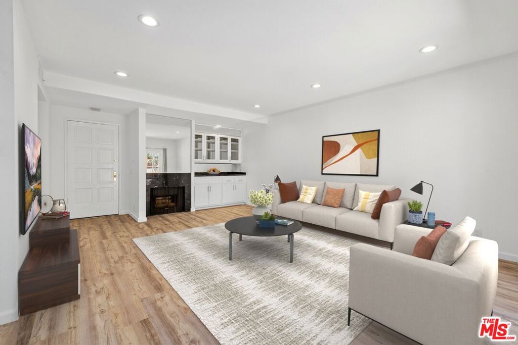 Completely renovated townhome in a prime Beverly Hills location. Features include new flooring, LED recessed lighting, relaxing fireplace, in-unit washer/dryer, skylights, central air/heat, formal dining room & a private patio. The upgraded kitchen includes Samsung stainless steel appliances, Quartz countertops, tons of cabinet space & large pantry for additional storage. Oversized primary suite with 2 balconies, a huge closet & custom spa-like bathroom. Secure 3-unit building situated on a palm tree lined street & only footsteps away from from La Cienega Park; perfect for outdoor activities and exercise. Additionally, Beverly Hills Tennis, coffee shops, bars, and a multitude of dining options on Restaurant Row are within easy reach. Rent includes water and garbage services, as well as a large storage room and two parking spaces for added convenience. Best of all, this property is pet-friendly, allowing you to enjoy the space with your furry companions.
