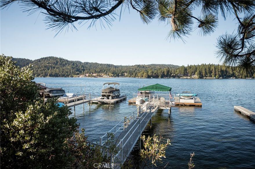 Ideally located on the North Shore, walking distance from Tavern Bay Beach Club, this deep-water dock offers both convenience and comfort. Access is easy with a gentle approach from the East parking lot or Shelter Cove. Built in 2021, it features Trex decking, a large party platform, and a canopy for shade and relaxation. Middle slip of three. ALA access #54, 55 & 58. Dock# N310B