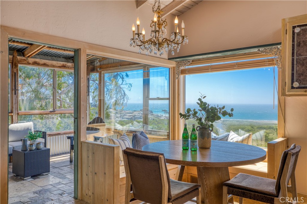 Unique Artist’s Retreat with Panoramic Ocean Views! Nestled in the desirable Happy Hills area overlooking Moonstone Beach, this distinctive property offers a 3-bedroom, 2-bath main home of approx. 1,930 sq. ft. plus a detached studio of approx. 500 sq. ft. Perfect as a private retreat, multi-generational living, or income opportunity, the home showcases sweeping ocean views from multiple vantage points. The main residence features vaulted wood-plank ceilings, travertine floors, and decorative stained-glass accents. An updated kitchen opens to the dining area, where large picture windows with built-in window seats frame the views and provide access to an enclosed deck—an ideal spot to relax and take in the scenery. Adjacent, the living room centers around a cozy fireplace, with stairs leading to the converted garage, formerly an art studio, easily repurposed as a family room. A half bath completes the main level. Downstairs, the primary suite offers an en-suite bath and private enclosed deck. Two additional bedrooms share a full hall bath and access to a wraparound deck that transitions to a larger covered outdoor space with storage. A staircase leads to the detached studio, complete with a full bath, kitchenette, laundry, and spacious deck—perfect for guests, extended family, or rental income. The 5,600 sq. ft. lot is complemented by an additional 2,575 sq. ft. parcel with meandering walking paths and seating areas, creating a serene, forest-like setting. Just minutes from charming shops, restaurants, and the iconic Moonstone Beach boardwalk, this home blends artistic character, versatile living, and breathtaking scenery.