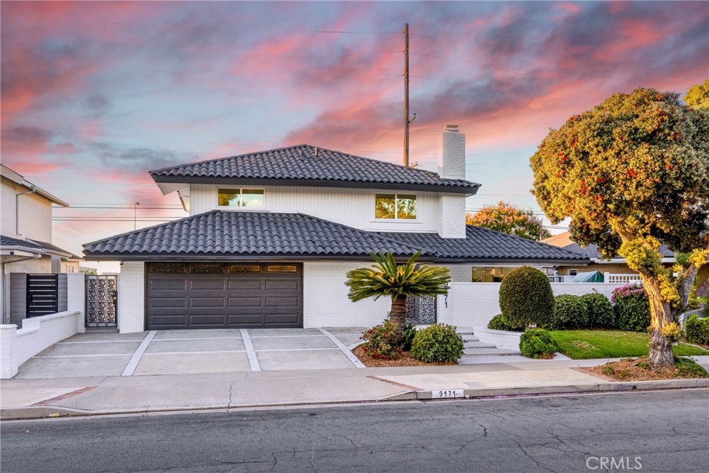 Experience the epitome of coastal luxury in this meticulously transformed residence ideally situated just a few blocks from the inviting sands of Huntington Beach and within the highly acclaimed Huntington Beach School District. This home has undergone a complete interior and exterior remodel, leaving no detail untouched, creating a harmonious blend of sophistication and modern comfort. Step inside and be greeted by the warmth of pristine highly durable engineered wood laminate flooring that extends throughout the home, leading through the brightly lit spacious living area that features an abundance of windows allowing for exceptional natural light to bathe the living spaces. A gourmet kitchen designed for both culinary artistry and lively entertaining is at the back of the home and overlooks the entertainer’s patio and yard. Gleaming quartz countertops provide ample prep and storage space, complemented by custom cabinetry with self-closing drawers and modern recessed lighting, ensuring every meal preparation and evening soirees are always a delight. Thoughtful in design, the floor plan includes an always sought after downstairs ensuite bedroom perfect for single level living or for the privacy of your guests. Upstairs the expansive primary suite elevates relaxation to an art form, featuring an opulent infinity bathtub where you can soak away the day's stresses. Three additional bedrooms, one featuring an ensuite bath, and a fully renovated dual sink vanity guest bath completes the living spaces. Further enhancing its allure are the significant upgrades that ensure both efficiency and comfort, including dual pane windows, an all new HVAC system and a showpiece epoxy-coated garage floor. Immerse yourself in the idyllic Southern California climate in the expansive backyard, a true oasis for outdoor living. The generous patio beckons for alfresco dining, lively gatherings, or simply unwinding under the warm sunshine. This isn't just a house; it's a meticulously reimagined home, offering a lifestyle of comfort, elegance, and unparalleled access to the vibrant coastal community of Huntington Beach. Don't miss this rare opportunity to own a turnkey masterpiece in one of Southern California's most coveted destinations. Welcome Home.