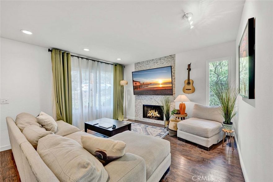 Welcome to this charming 3-bedroom, 2.5-bath, 1,190 sq. ft. end-unit townhome nestled in the Villeurbanne community of Orange, offering peaceful hillside views and a comfortable layout. Step inside to a bright living room with a cozy fireplace and ample natural light, flowing into the dining area and kitchen. The kitchen features quartz countertops and a double oven, with sliding doors to the private patio, an ideal spot for morning coffee or casual dining. Upstairs, the primary suite offers a spacious closet and en suite bathroom, complemented by two additional bedrooms and a full hall bath. Additional conveniences include in-unit laundry and a detached one-car garage. Residents enjoy access to resort-style amenities, including a pool, spa, and clubhouse. Just minutes from Orange Hill Restaurant, Old Towne Orange, Peters Canyon and Irvine Regional Parks, shopping, dining, and major freeways, this home offers both comfort and connection to all that Orange has to offer!