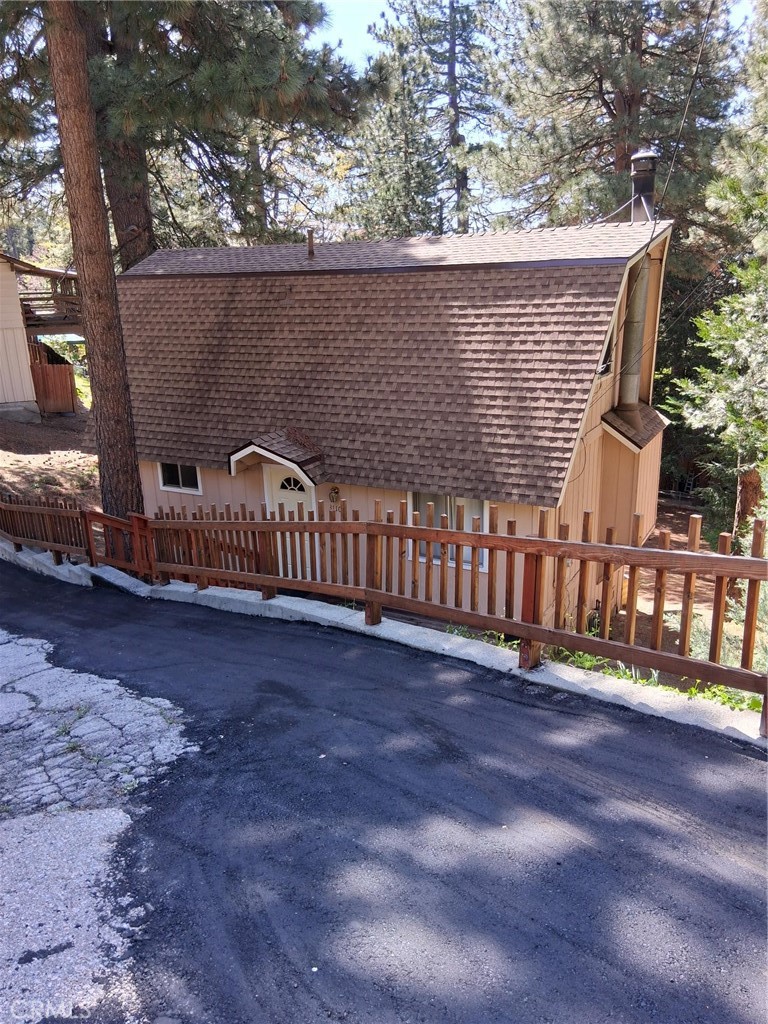This two bedroom house is ready for you to step in. Both bedrooms are upstairs and have several windows to make the rooms light. A full bathroom on the main level has tub and shower. In the kitchen is a closet with a washing machine, no dryer is included. The kitchen has good counter space and stainless steel sink. There is a stove, refrigerator and new dishwasher. Eating area in kitchen between kitchen and living room. Sliding glass doors lead to deck from kitchen and living room. There is a wood burning fireplace in the living room. Off street parking in the driveway for two cars parked tandem. Come check it out.