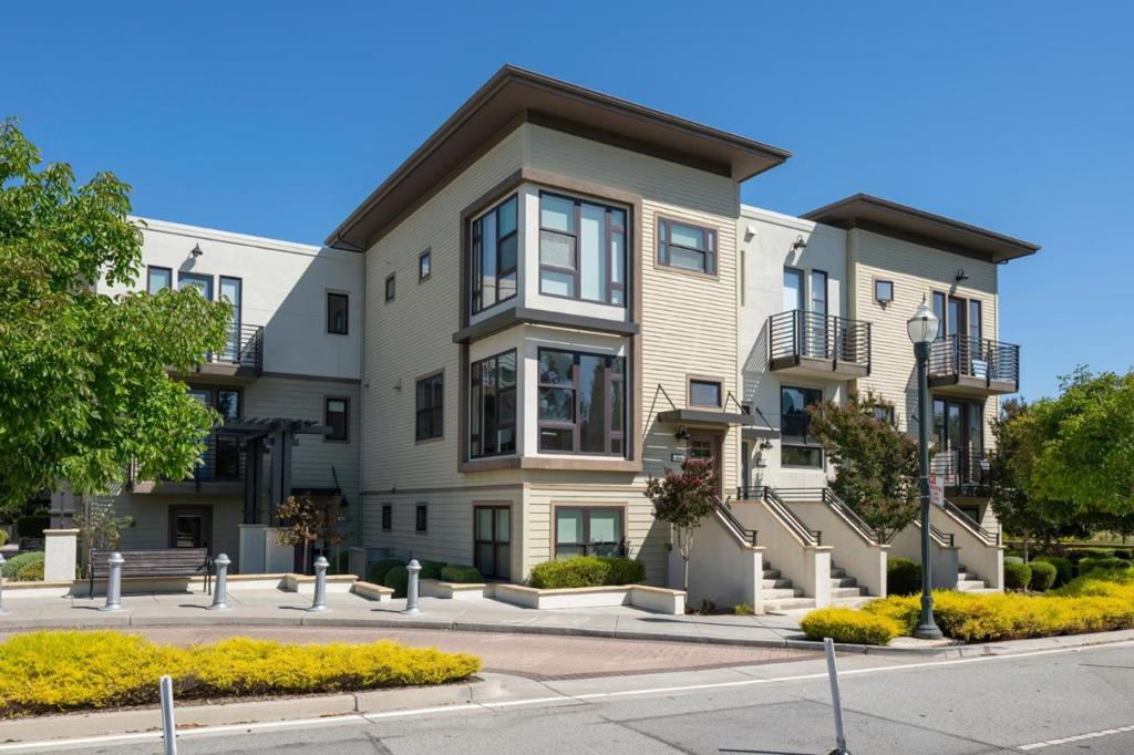 Flooded with natural light from expansive windows, this spacious corner unit offers 4 bedrooms, 4 bathrooms, and approximately 2,454 sq. ft. of thoughtfully designed living space. Built in 2017, the home features sleek architecture and an open concept layout ideal for todays lifestyle. The chefs kitchen is a centerpiece with a six burner gas range, quartz countertops, custom cabinetry, and an oversized island perfect for entertaining. The retreat style primary suite includes a walk in closet and spa inspired bath, while additional bedrooms, including a convenient downstairs suite, provide flexibility for guests, an office, or playroom. Designer upgrades include white oak floors, custom closets, solar shades, surround sound, built in lighting, and a Nest system. The attached two car garage is finished with epoxy floors and cabinetry, while a tankless water heater and other energy efficient systems ensure modern comfort. Located in the heart of Bay Meadows, this home offers unmatched convenience with coffee shops, dining, and parks just steps away. Residents enjoy 18 acres of green space, playgrounds, community gardens, and bike paths, and close to Whole Foods & Hillsdale Mall. Commuting is effortless with Caltrain and quick connections to Highway 101 and 280.