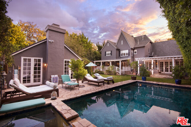 Exceptional Traditional home set behind gates in prime Beverly Hills Flats. Designer details include soaring, vaulted wood beam ceilings, multiple fireplaces, hardwood floors, French Doors throughout and luxury finishes. Gourmet Chef's kitchen features marble countertops and Viking appliances as well as a bright, open plan with den & breakfast nook. Serene backyard features sparkling pool, spa, outdoor patio with BBQ and various outdoor entertaining areas. Luxuriate in incredible indoor-outdoor living accented by French doors throughout. This 4 bedroom, 4.5 bath home also includes a detached guesthouse that features 2 beds, 2 baths, a spacious living room with fireplace and wetbar, for a total of 6 bedrooms and 6.5 bathrooms. The entire property is flanked by mature hedges and trees creating an incredibly private setting just blocks away from the best shops, restaurants, and nightlife Beverly Hills has to offer.