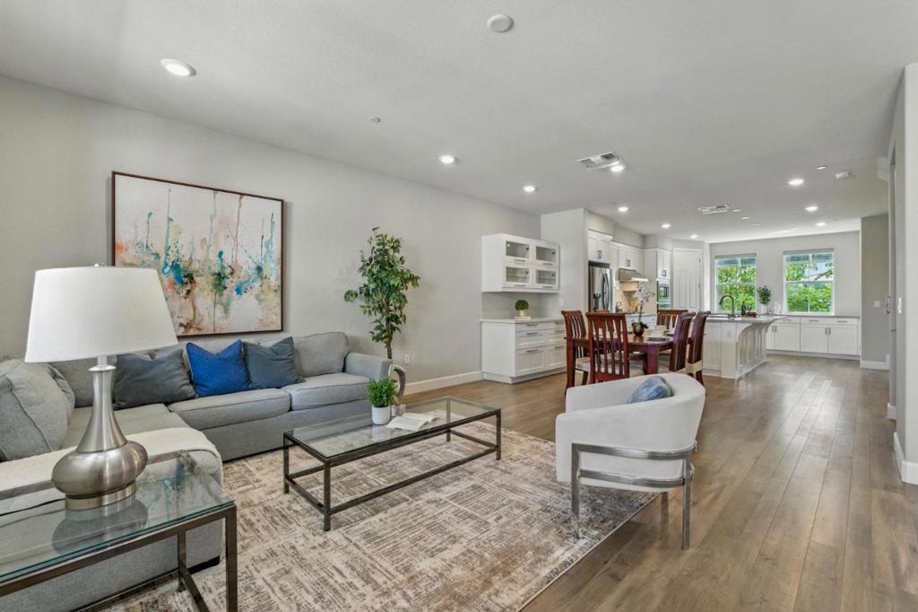 Luxurious and energy-efficient 5-year-new townhome located in a top-rated school district, privately situated in one of the most desirable spots within the community. This spacious, modern home features a private in-unit elevator serving all three levels, motorized window blinds, multi-zone central HVAC, a tankless water heater, and fully owned solar panels. The open-concept gourmet kitchen boasts quartz countertops, a chefs gas cooktop, slide-out shelves in the lower cabinets, a large pantry, and a wine rack built into the center island. The home offers three en-suite bedrooms, including a ground-floor suite-perfect for guests or rental use-and two expansive suites on the top floor, each with walk-in closets. Additional highlights include a side-by-side attached garage pre-wired for EV charging, washer/dryer on the top floor, new carpet, and fresh interior paint throughout. Community amenities feature a fitness area for adults, shaded seating bench area, and shared EV charging stations. Conveniently located within walking distance to the Age Well Center and Warm Springs Elementary School, and just minutes from Ranch 99, Osaka Market, Safeway, dining options, BART, and Highways 680/880.