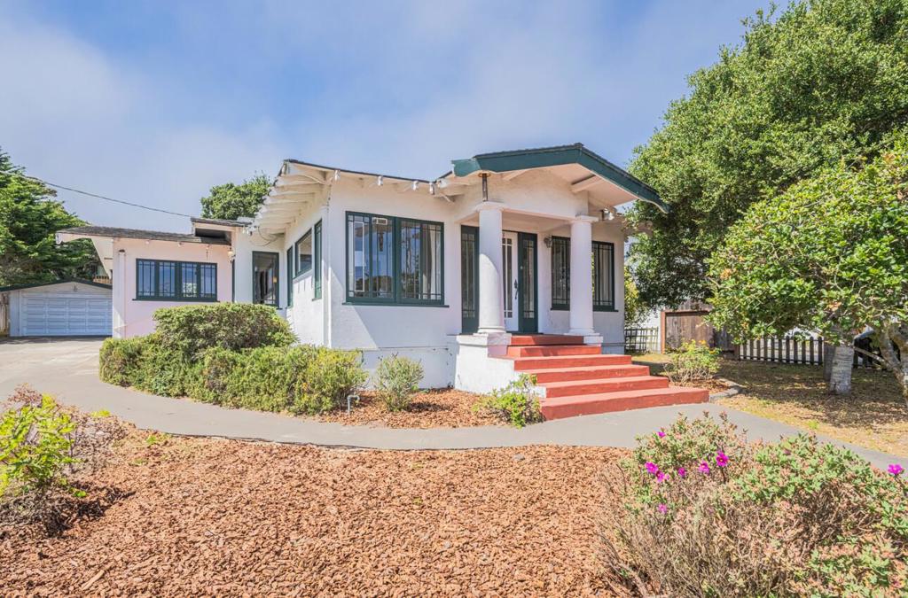 Owned by the same family for over sixty years, this two-bedroom refurbished charmer is located in arguably Pacific Grove's finest neighborhood. A fantastic example of a classic Craftsman cottage, it is situated on a spectacularly large, nearly quarter-acre lot on a quiet street just a few blocks to the coastline. Approximately 1,300 square feet, the light and bright floor plan offers a spacious formal dining area with traditional built-ins, an adorable living room with fireplace, and a generously-sized kitchen ready for the next owner's personal touch and updates. The private, expansive backyard with a long driveway and detached two-car garage offers an abundance of off-street parking and is perfect for gardening or future expansion. Whether you're looking for a move-in-ready retreat or a property with room to grow, this charming home perfectly captures the timeless character and historic appeal of America's Last Hometown.