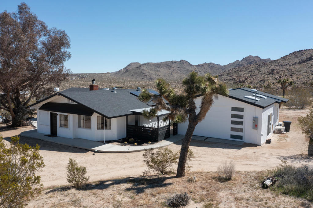 Welcome to 9073 Tortuga Trail, where desert tranquility meets modern comfort in the heart of Joshua Tree, California! Are you looking for a forever home? vacation home? or one with potential rental possiblilities? This is it! Nestled amidst the rugged beauty of the Mojave Desert, close to the entrance of the monument, this captivating property offers a lifestyle of unparalleled serenity and style. Here you will find both home, and extra guest space. The home offers 3 bedrooms, 2 baths, and the converted oversized garage offers additional guest space and a 3rd bathroom, 2538 square feet combined. A hot tub also graces this gorgeous 2.5 acre piece of land. It has been beautifully updated to modern expectations and boasts solar for efficiency, and a new roof.Step into your own desert oasis, where the vast expanse of the landscape becomes your backyard and breathtaking sunsets paint the sky. This meticulously designed home provides ample space for relaxation and entertainment.Escape to the luxurious master suite, where you can unwind in your private sanctuary complete with stunning desert views. Each bedroom offers comfort and privacy, ensuring that every member of the household has their own retreat.Step outside to your patio area, where you can bask in the warmth of the desert sun or stargaze under the vast desert sky from the hot tub.